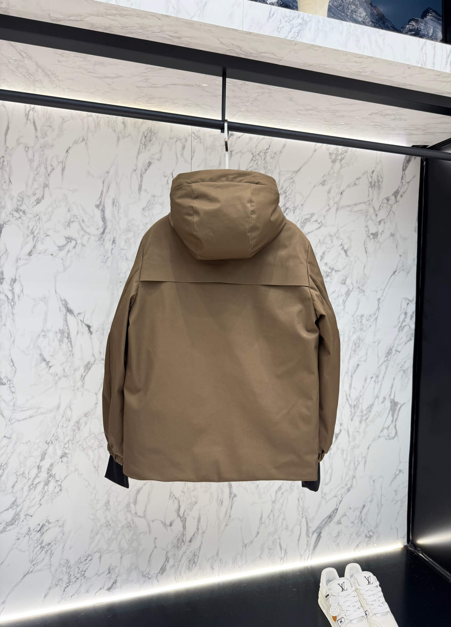 Brown hooded technical jacket with front snap closure and zippered pockets, Moncler-inspired design
