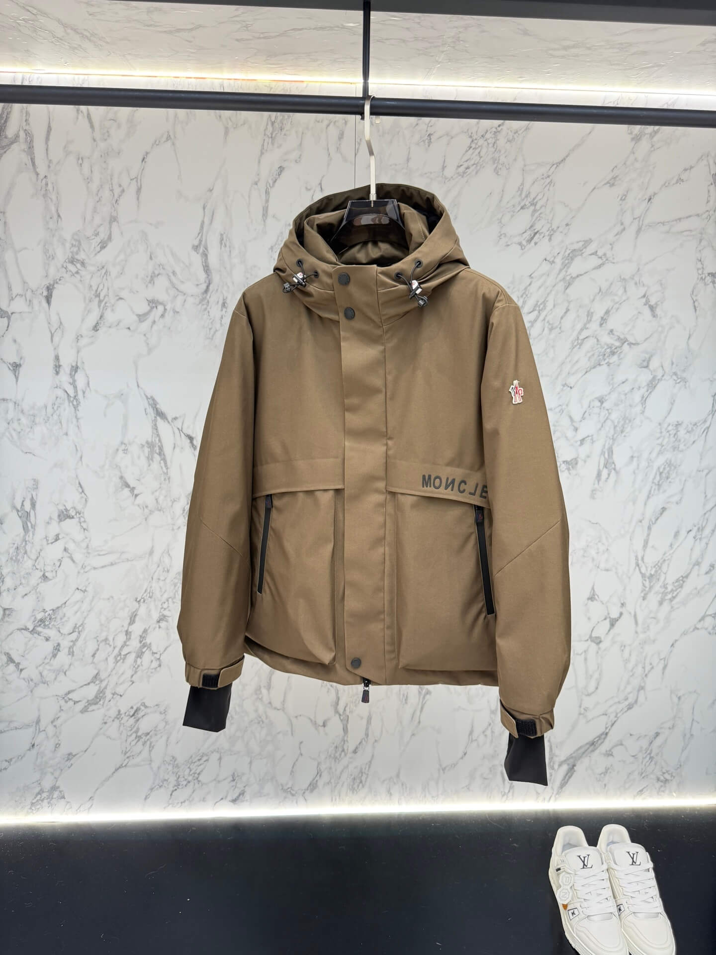 Brown hooded technical jacket with front snap closure and zippered pockets, Moncler-inspired design