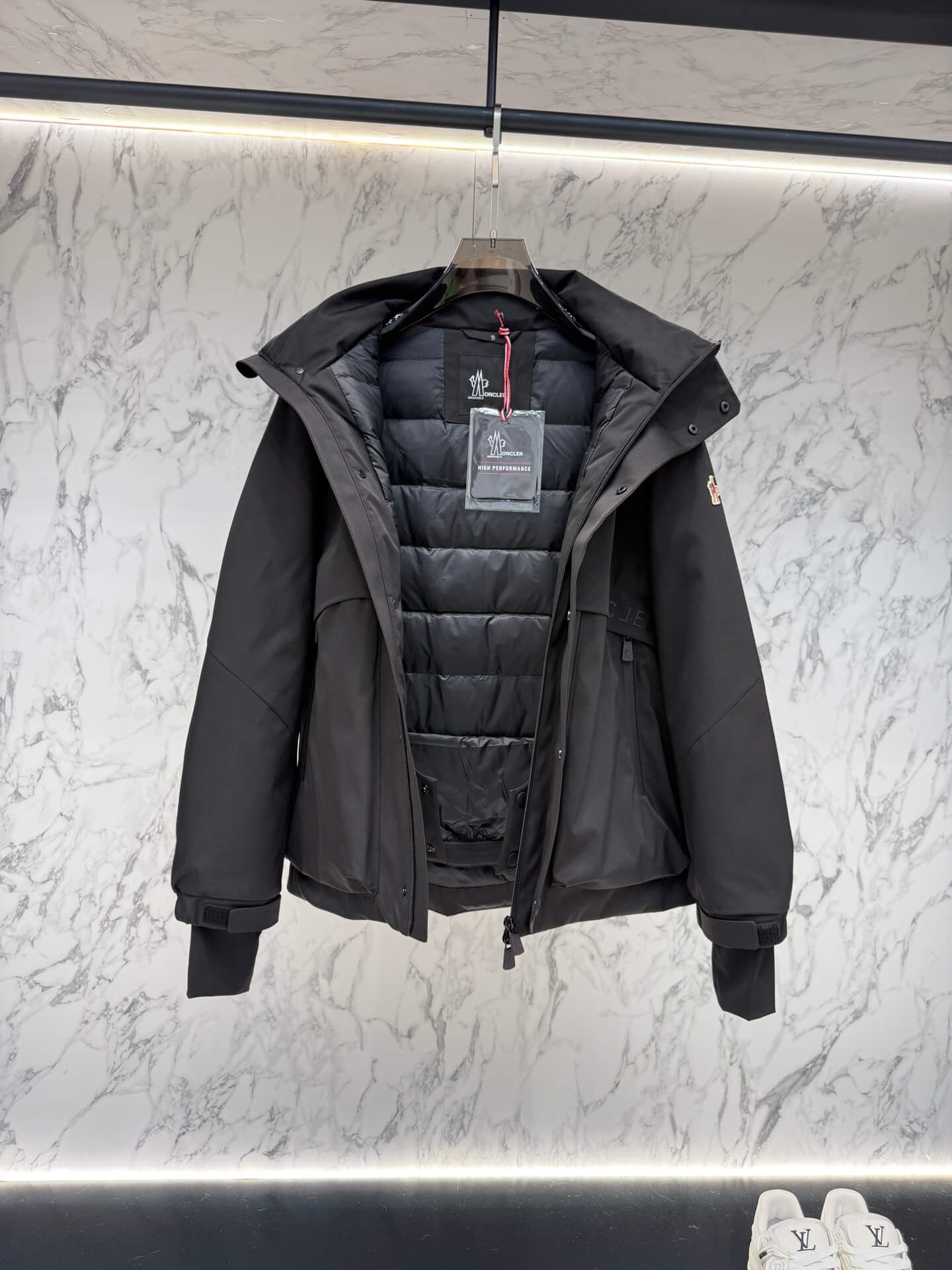 Moncler Maya Black Short Down Jacket open view showing quilted interior and label.