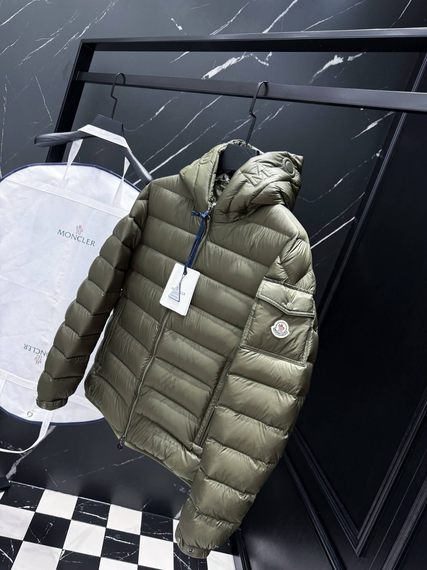 Green hooded glossy down jacket with quilted panels and zippered pockets, Moncler Maya-inspired design.
