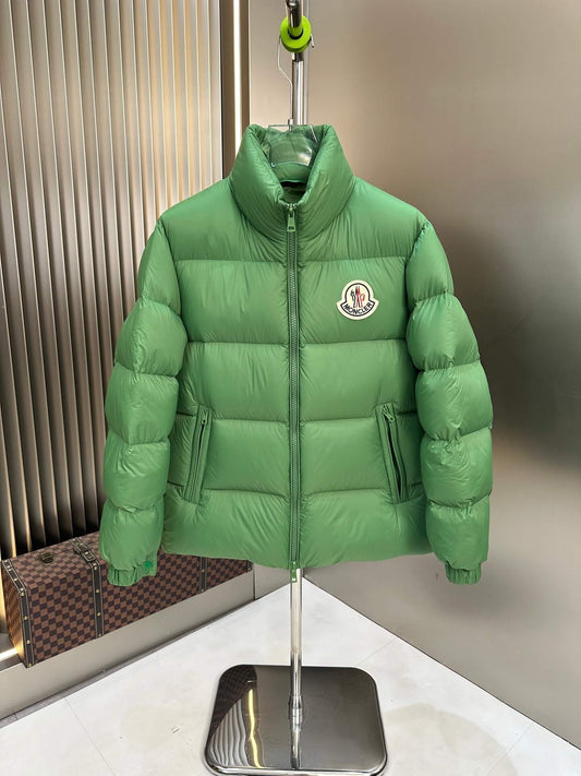 Moncler Maya Green Hooded Short Down Jacket displayed on a stand, showcasing its vibrant color and Moncler chest logo.
