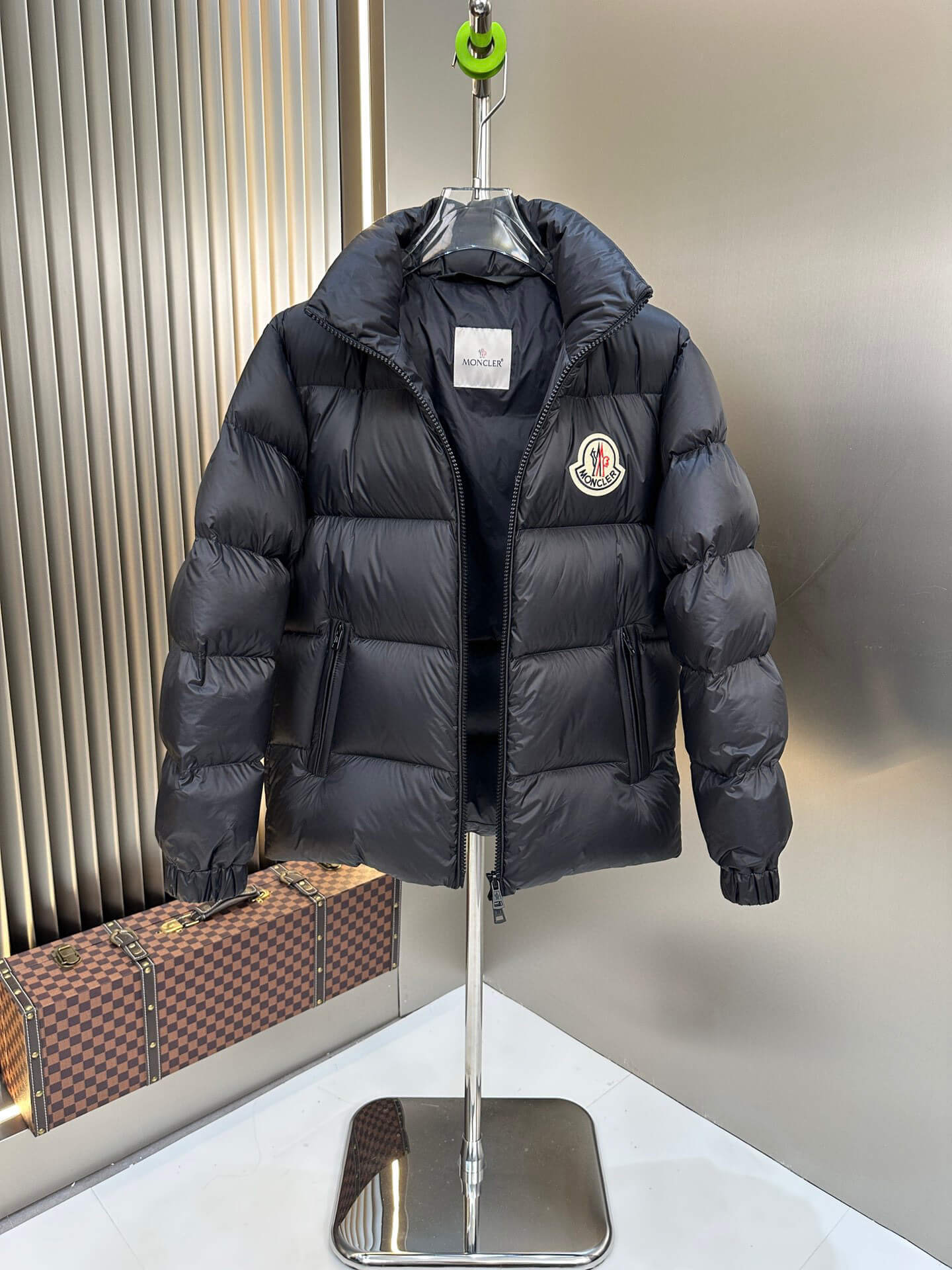 Black shiny down puffer jacket with hood and high collar, Moncler-inspired design, front view on mannequin.