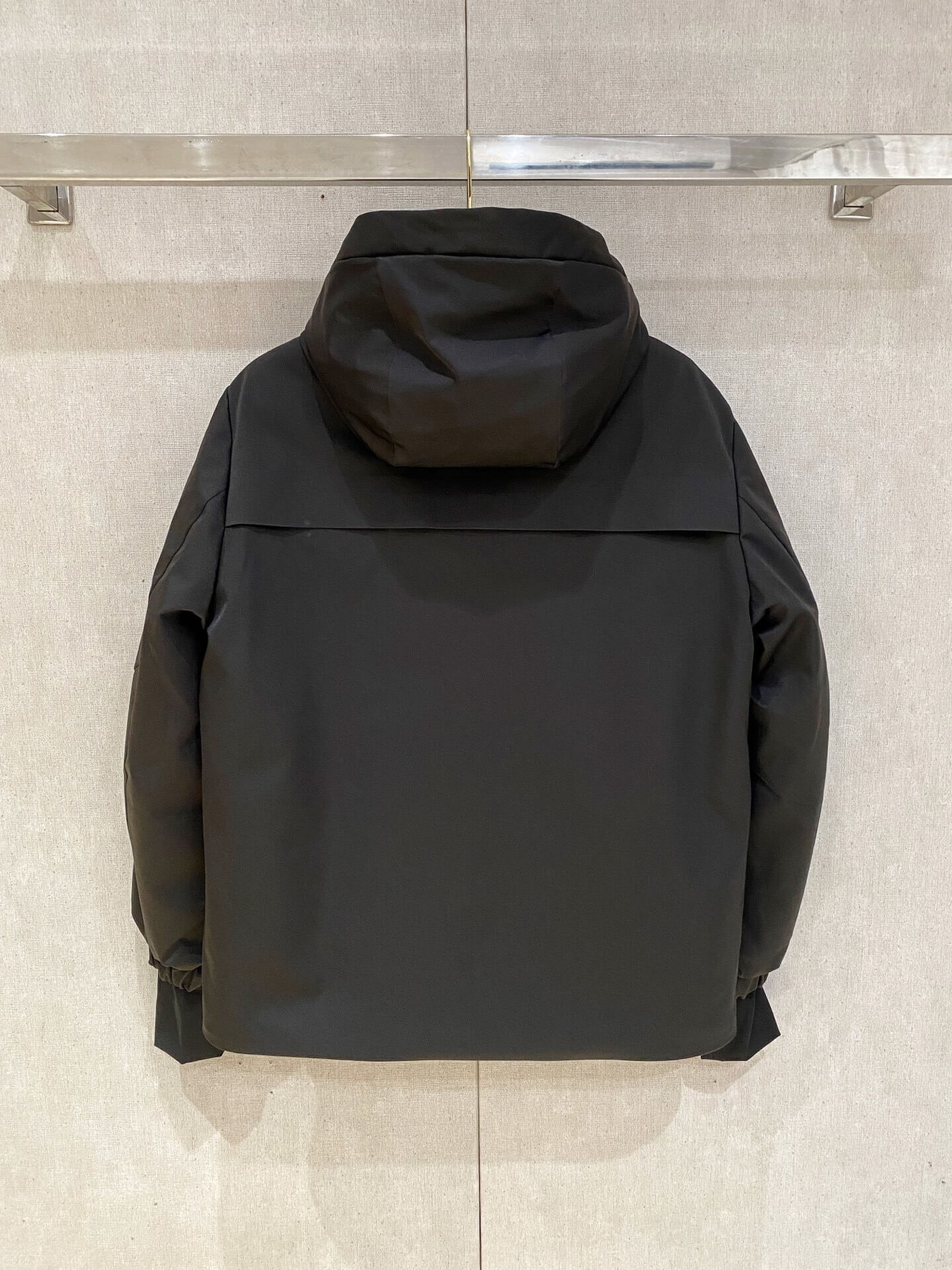 Black Moncler-inspired men’s Maya down jacket with quilted puffer design, detachable hood, and front zip closure, displayed on hanger.