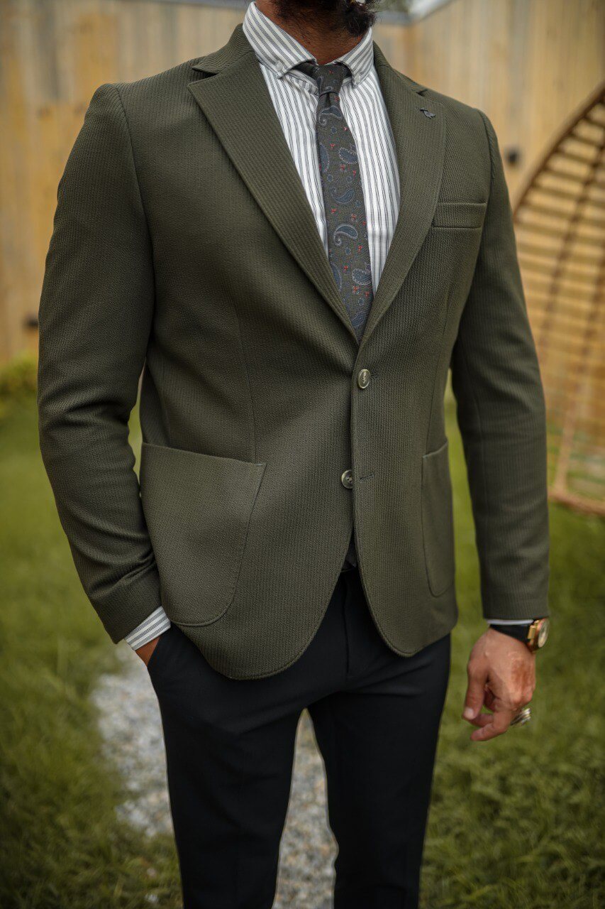 Olive green textured blazer with mono collar and pocket details paired with black slim-fit trousers, styled as a modern men’s combination suit.