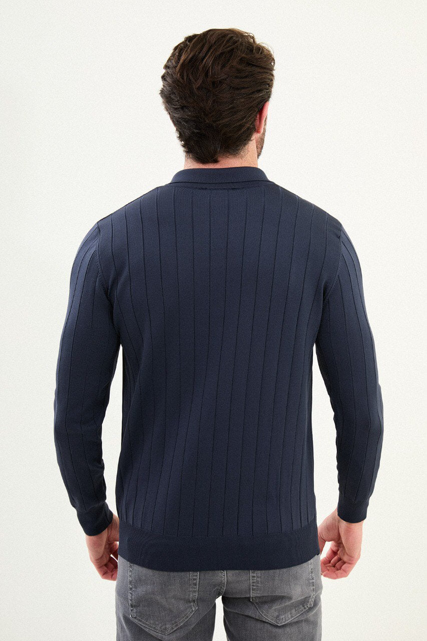 Men’s navy ribbed long-sleeve polo sweater with three-button placket and vertical rib knit texture, cotton-viscose stretch blend, styled with gray denim.