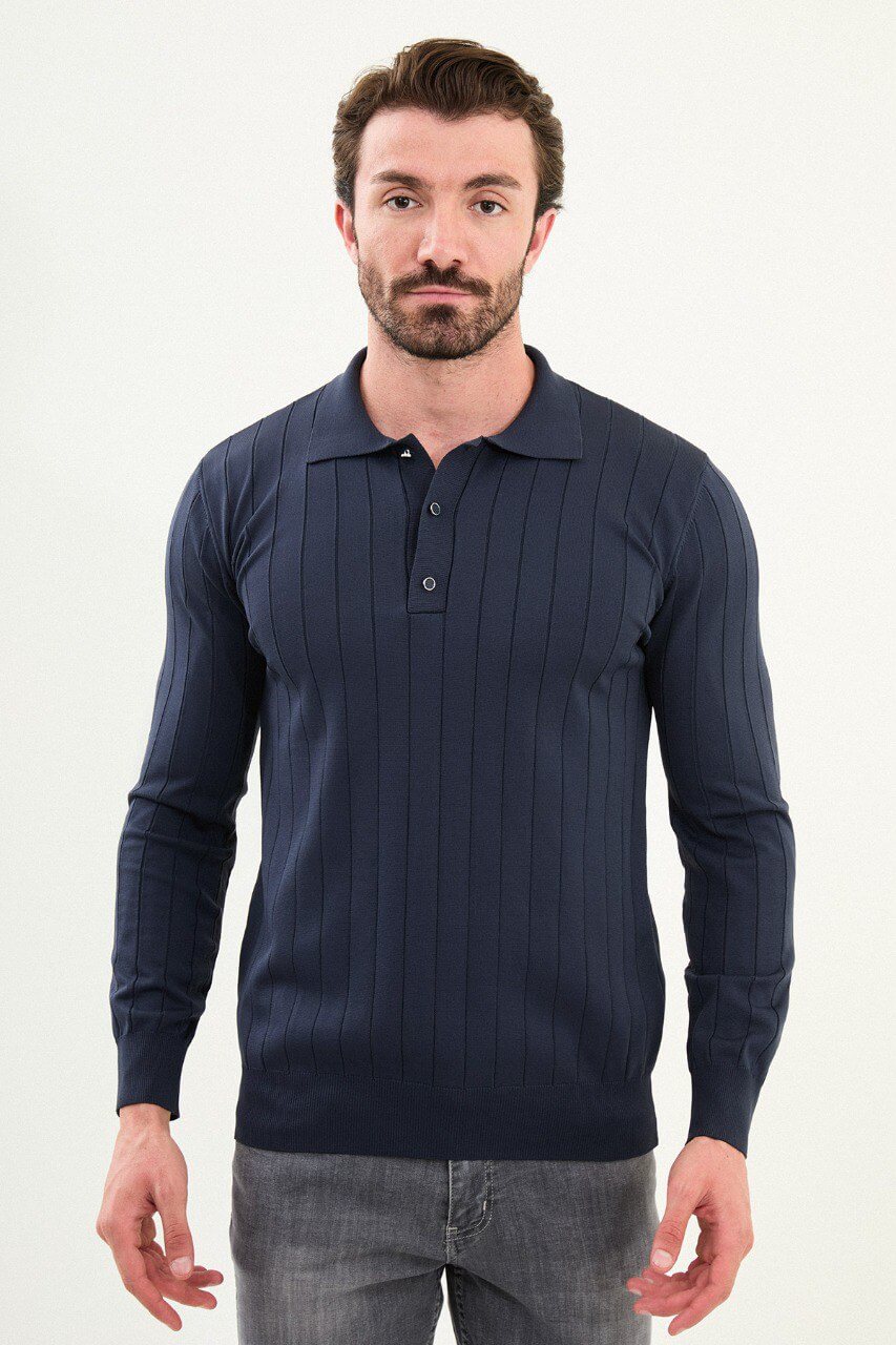 Men’s navy ribbed long-sleeve polo sweater with three-button placket and vertical rib knit texture, cotton-viscose stretch blend, styled with gray denim.