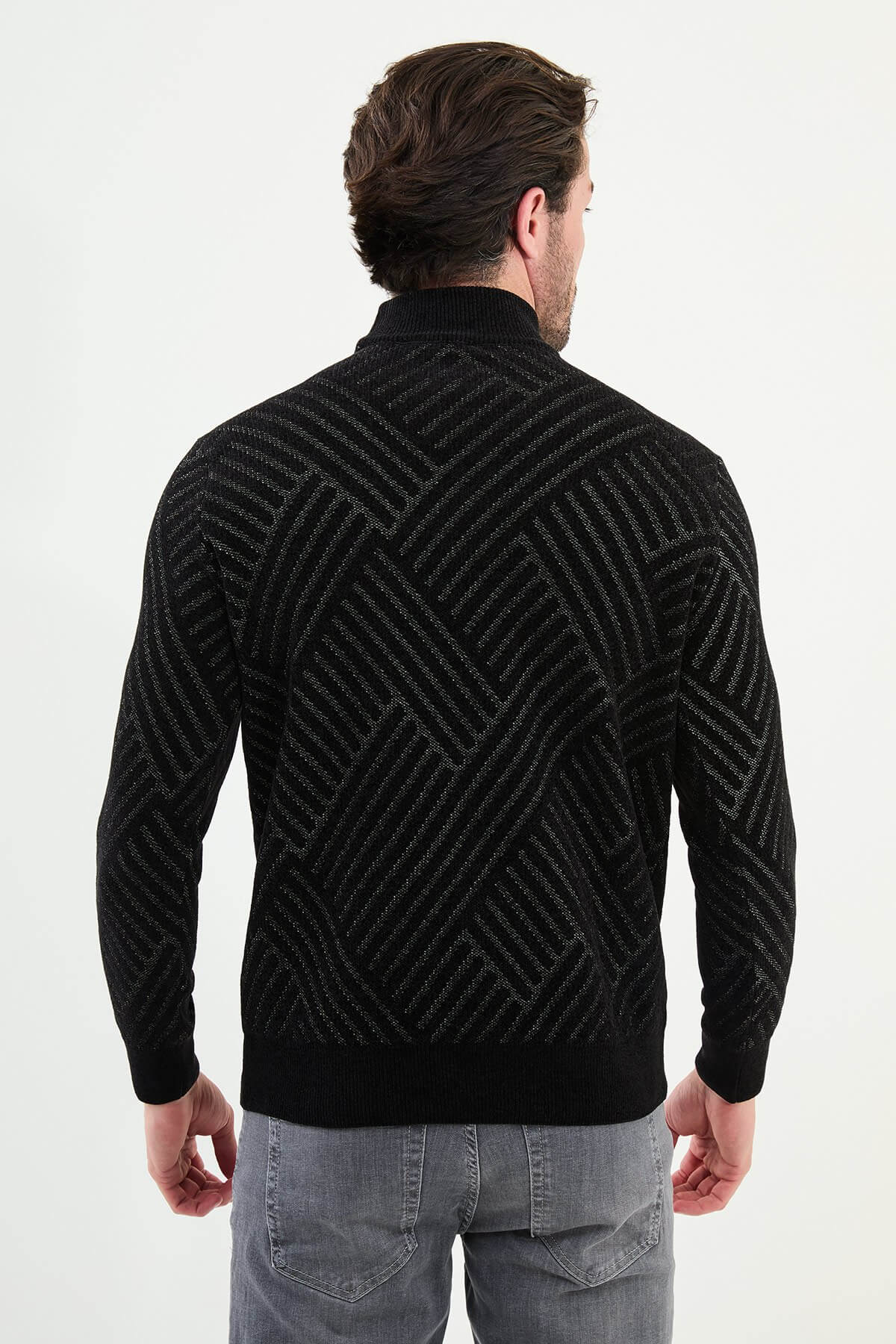 A men’s slim fit black patterned turtleneck sweater with geometric detailing, styled for the Fall-Winter collection.