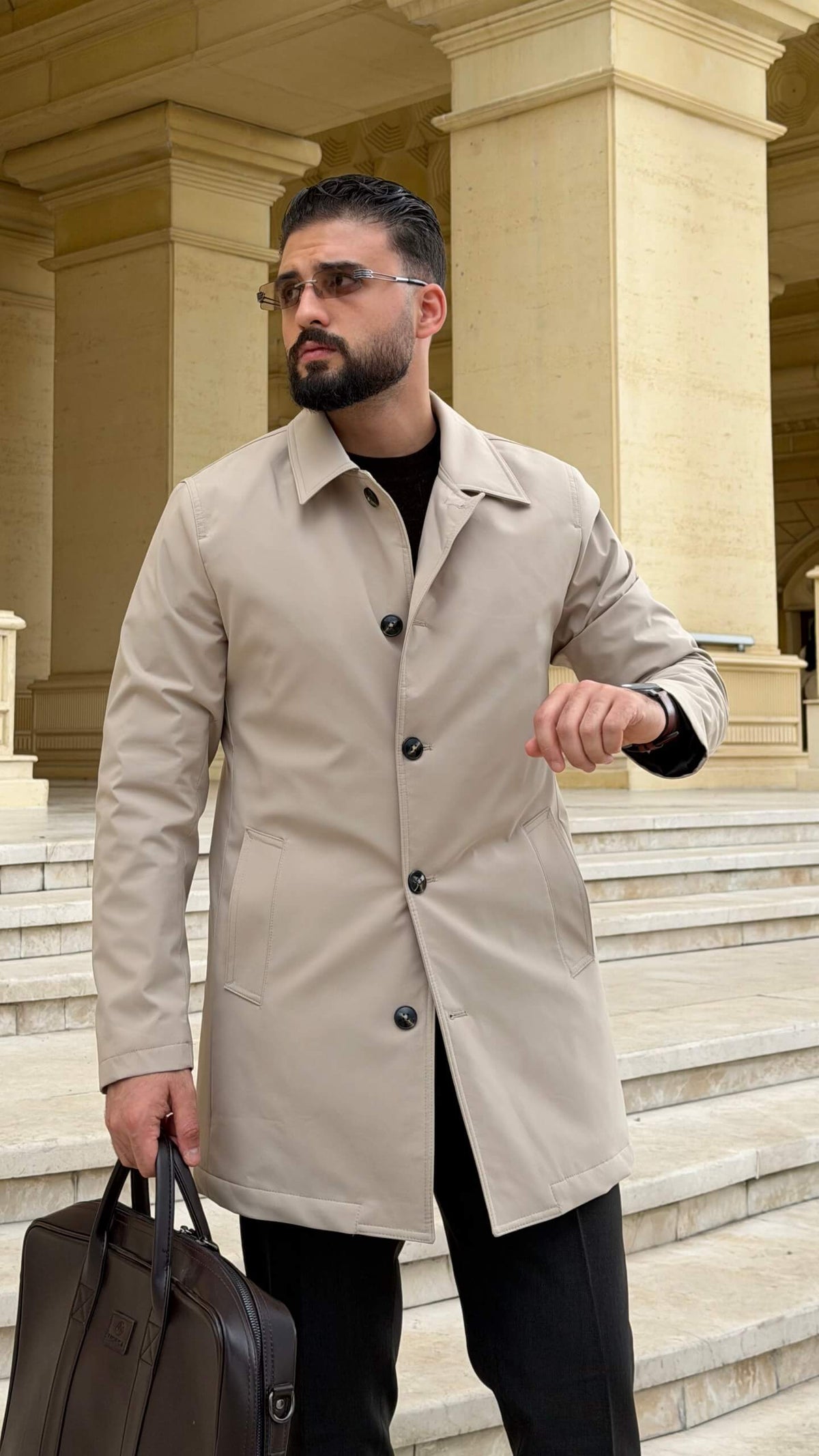 Men wearing a beige single breasted trench coat with button closure and side pockets