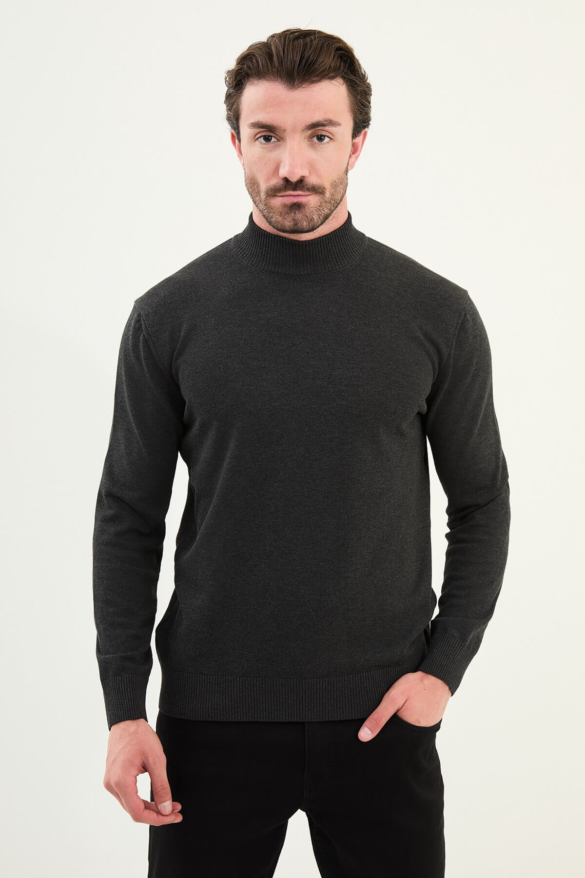 Man wearing a dark gray slim fit half-turtleneck sweater from the Fall-Winter collection.