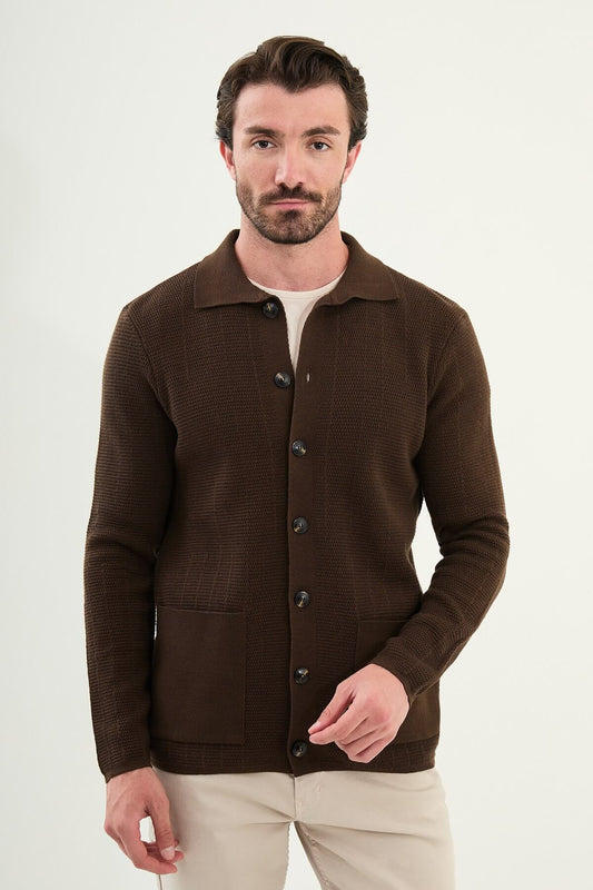 A man wearing a brown slim fit button-up cardigan with front pockets, paired with beige chinos and brown sneakers.