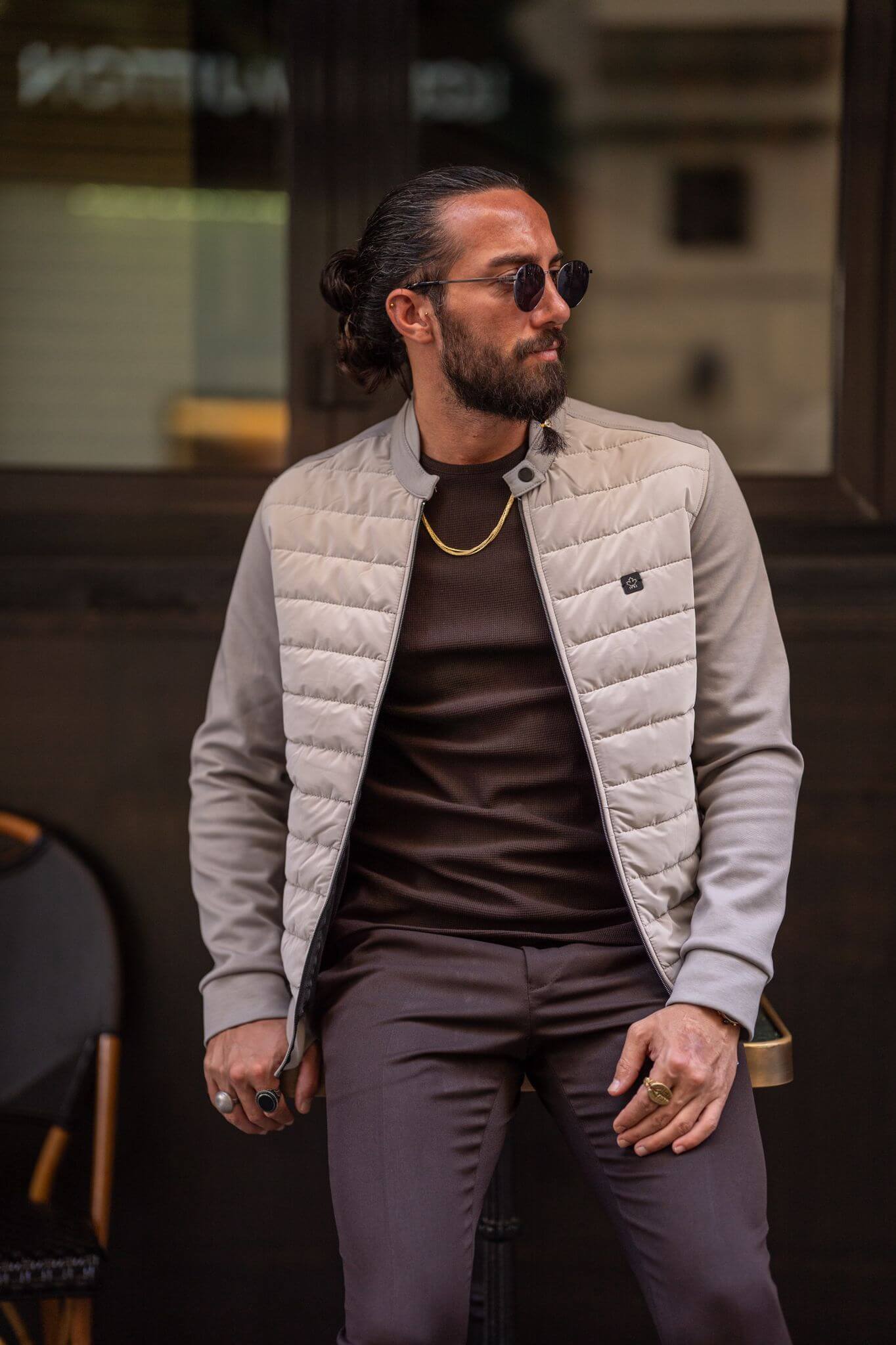 The epitome of sartorial charm, our male model presents a striking image in a beige coat.