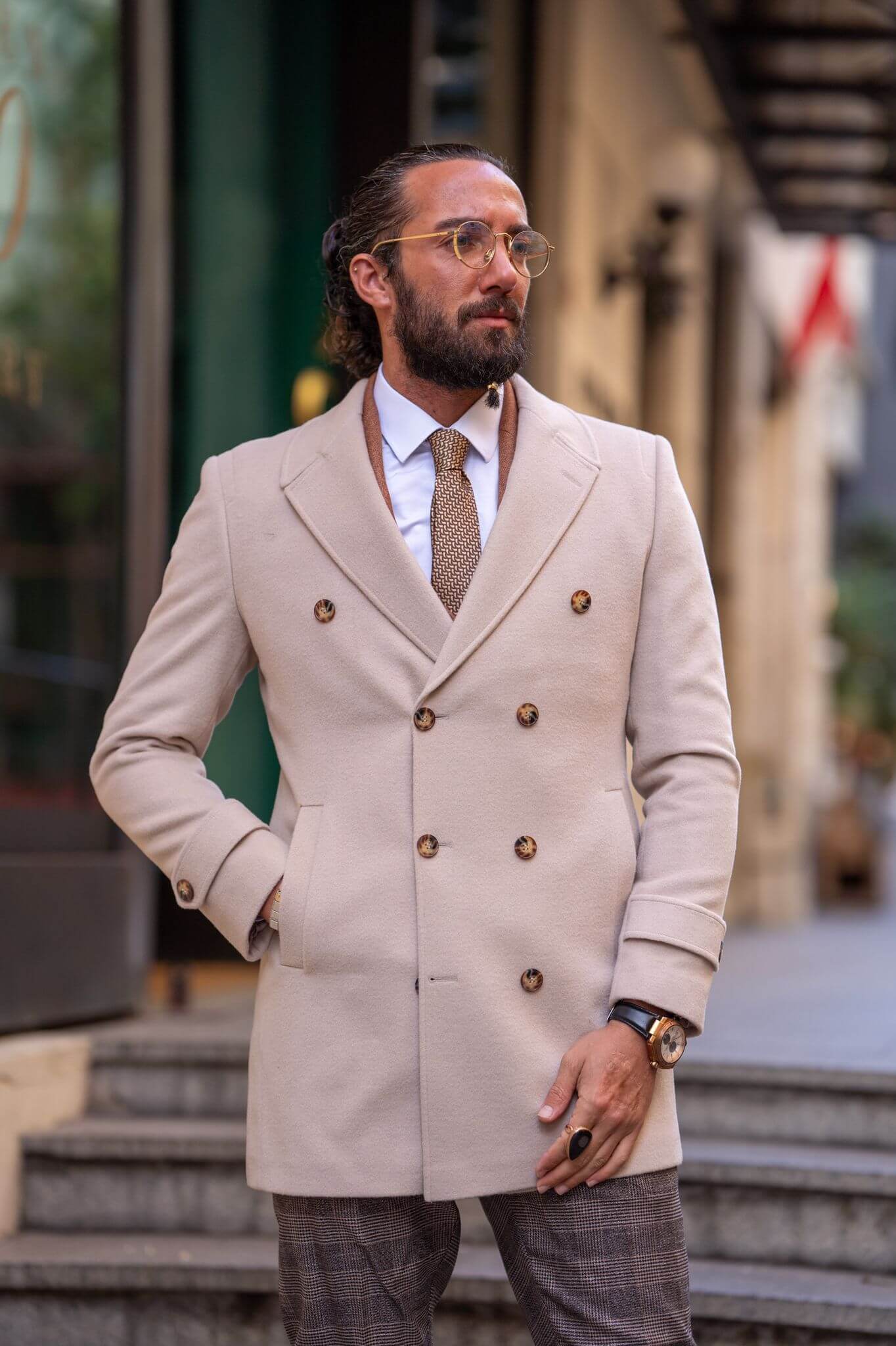 Captivating shot of our stylish male model confidently presenting the timeless elegance of our beige coat.