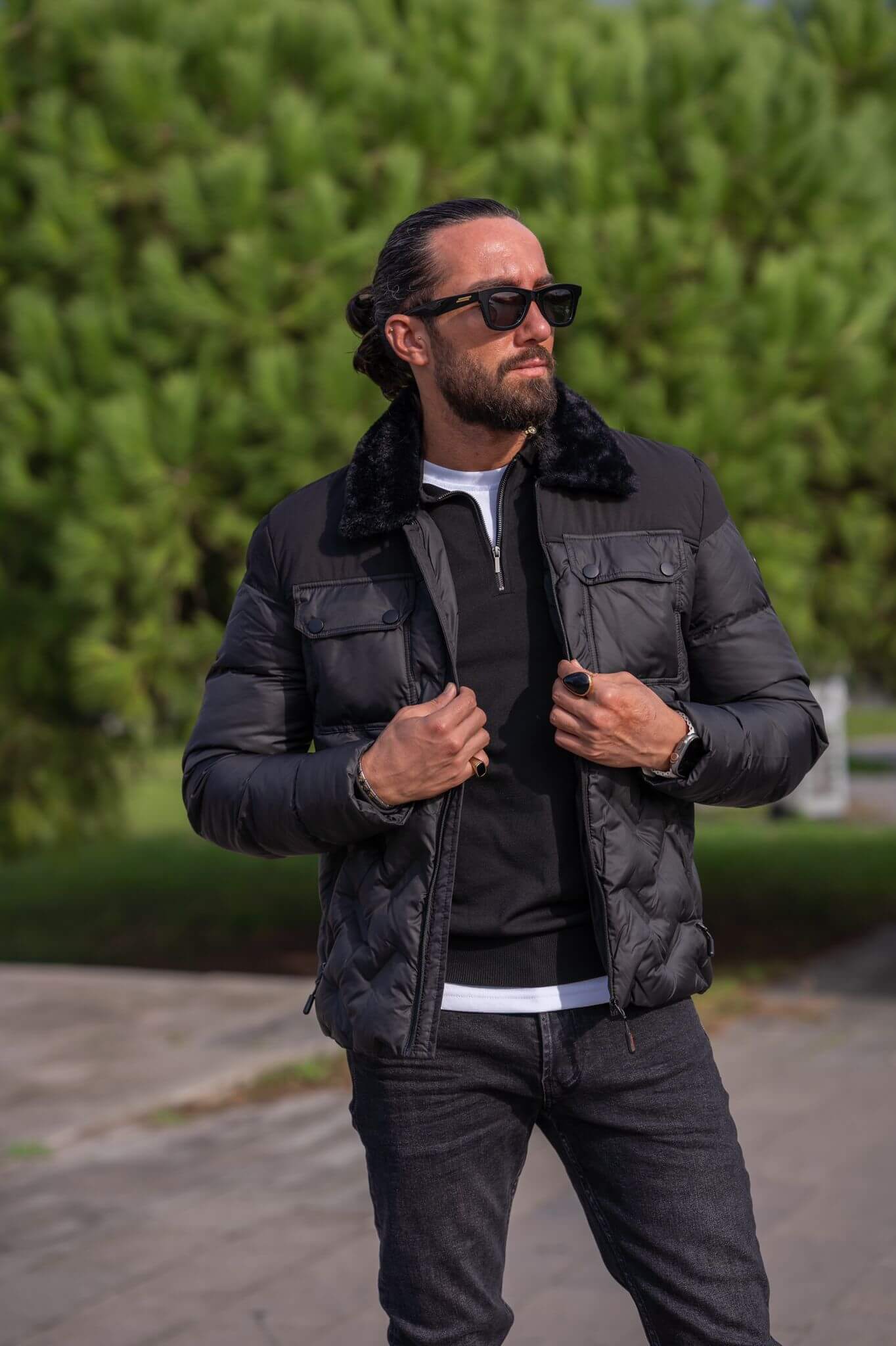 A stylish male model confidently wears our sleek black bomber jacket, exuding urban cool vibes."