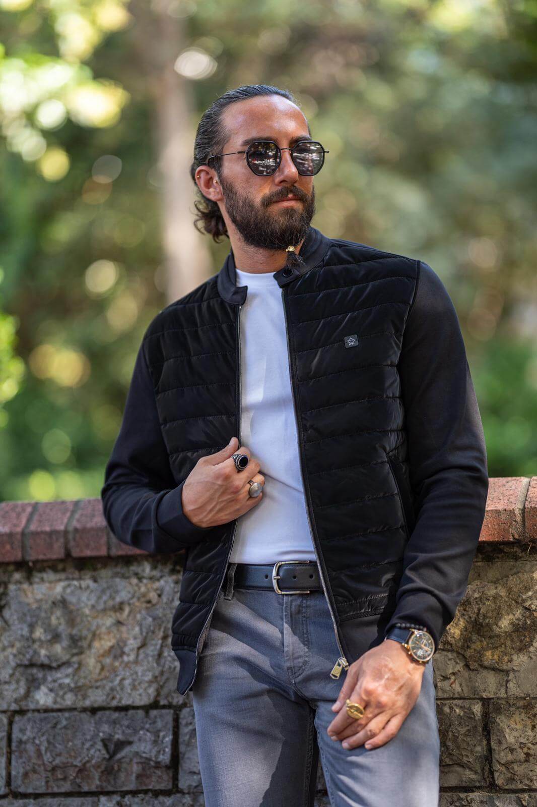 Male model donning a stylish black coat, embodying modern fashion elegance.