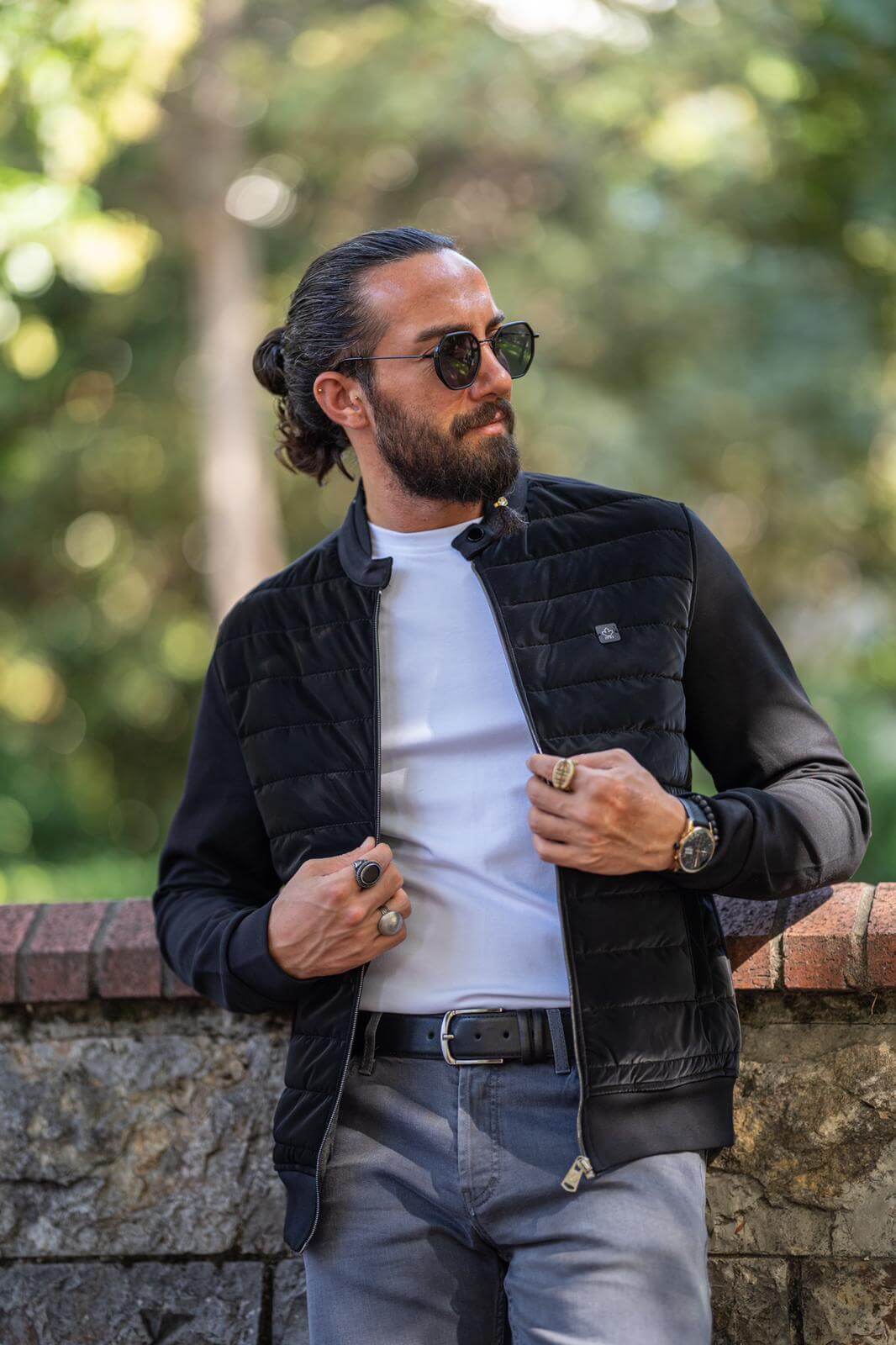 Male model donning a stylish black coat, embodying modern fashion elegance.