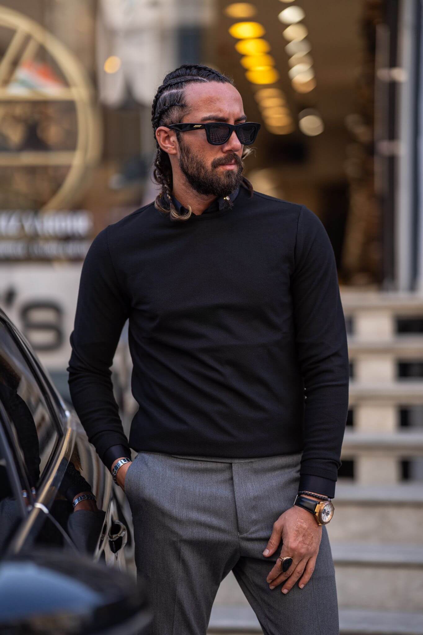 Casually chic: Our male model effortlessly rocks a black crewneck, epitomizing laid-back elegance.