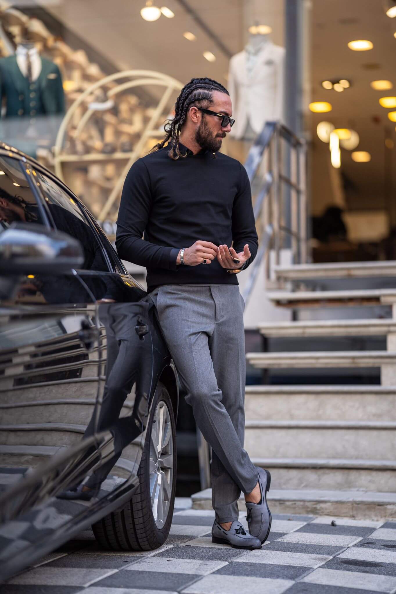 Casually chic: Our male model effortlessly rocks a black crewneck, epitomizing laid-back elegance.