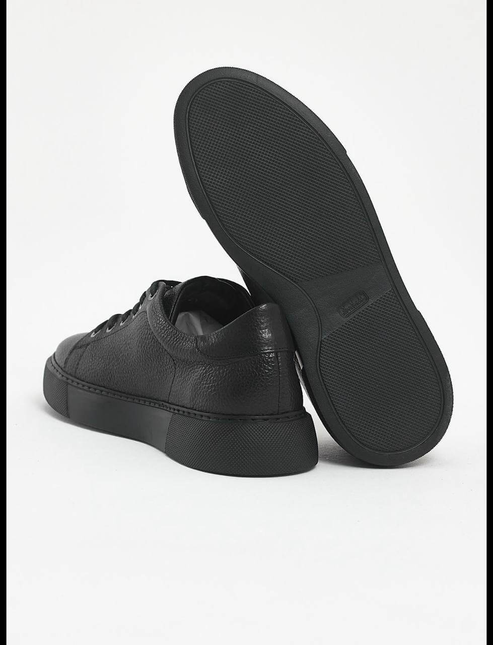 Black leather sneakers with textured floater leather and matching black EVA sole. 