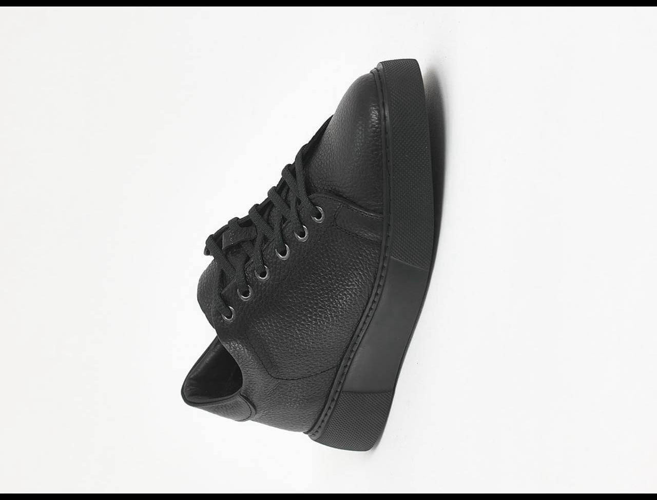 Black leather sneakers with textured floater leather and matching black EVA sole. 