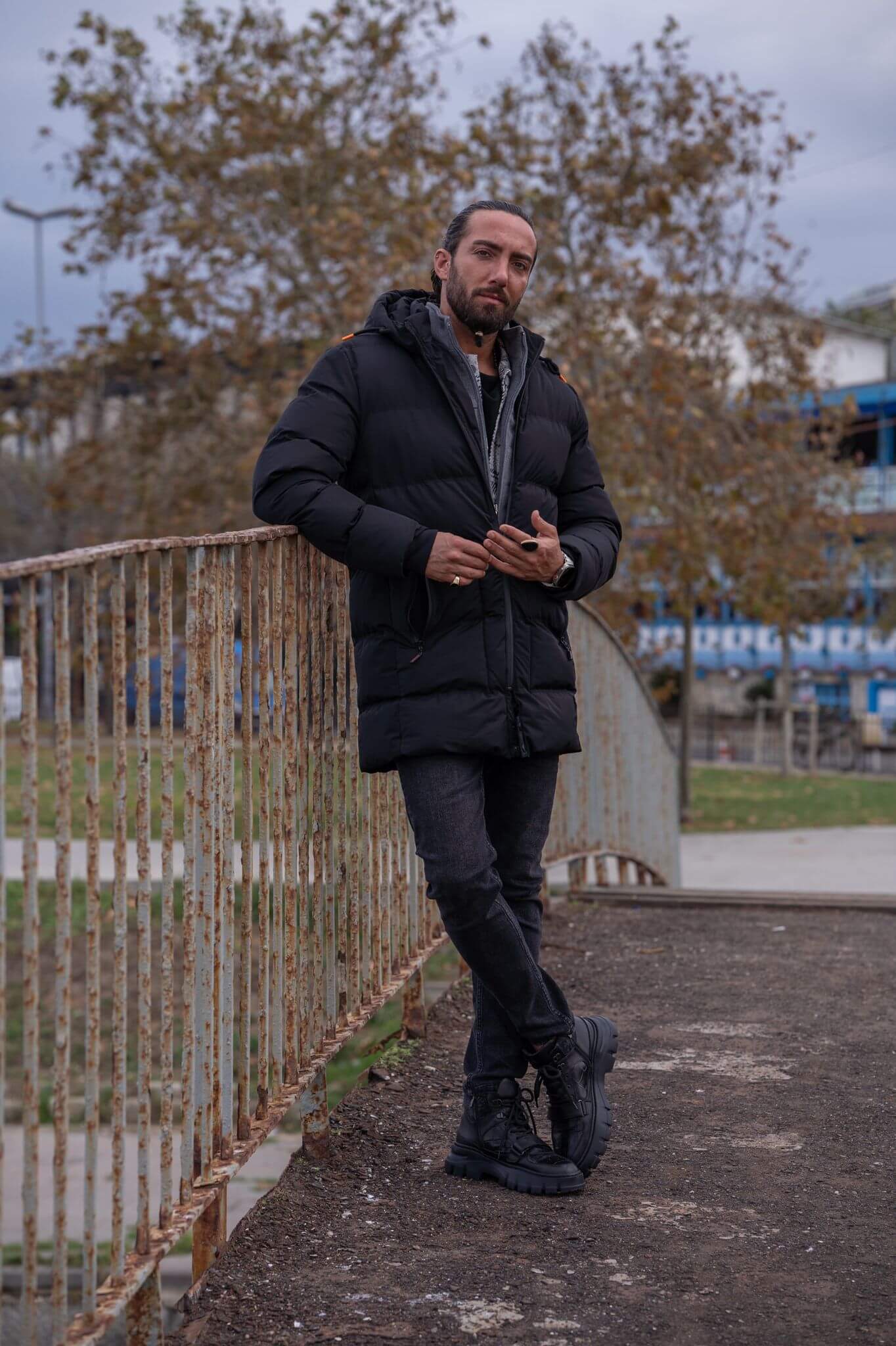 Striking male model confidently displays the sleek and stylish black puffer jacket.