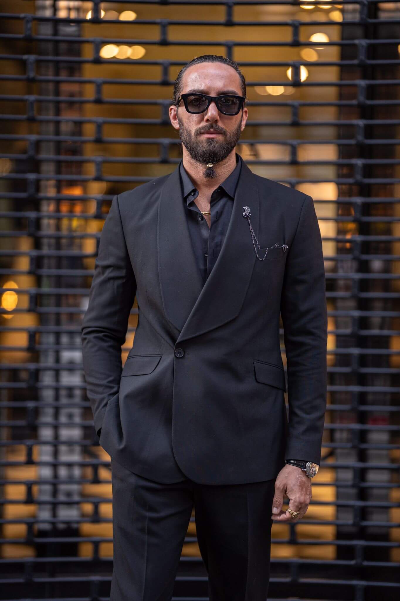 A stylish male model confidently displays a Black Wide Shawl collar, exuding sophistication and charm.