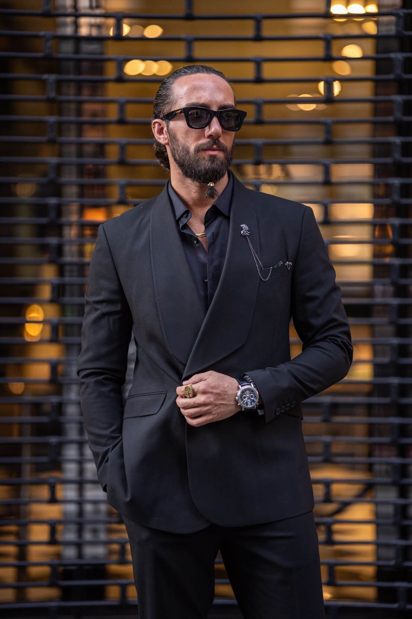 A stylish male model confidently displays a Black Wide Shawl Collar, exuding sophistication and charm."