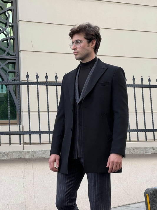 Striking male model in a sleek black coat, exuding sophistication and style