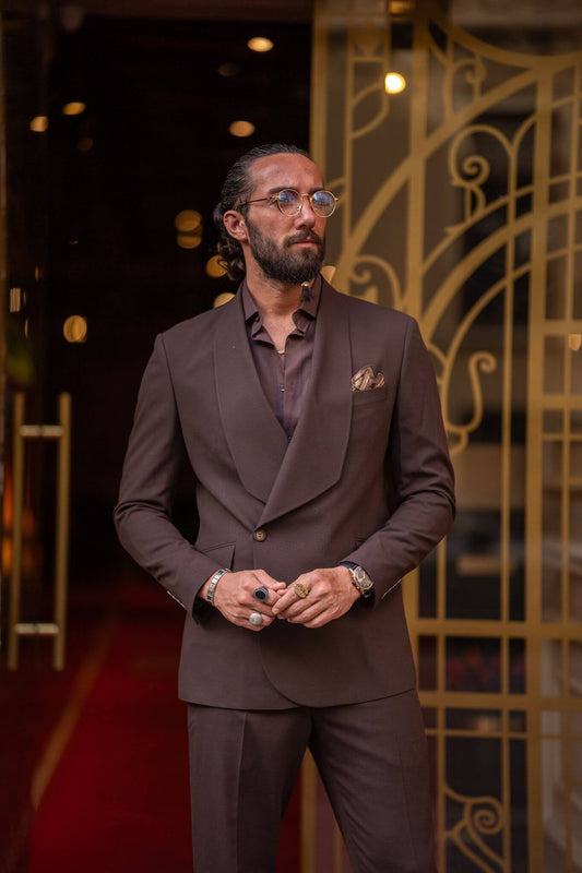 A dapper male model confidently flaunting a brown Shawl Collar in a stylish fashion ensemble.