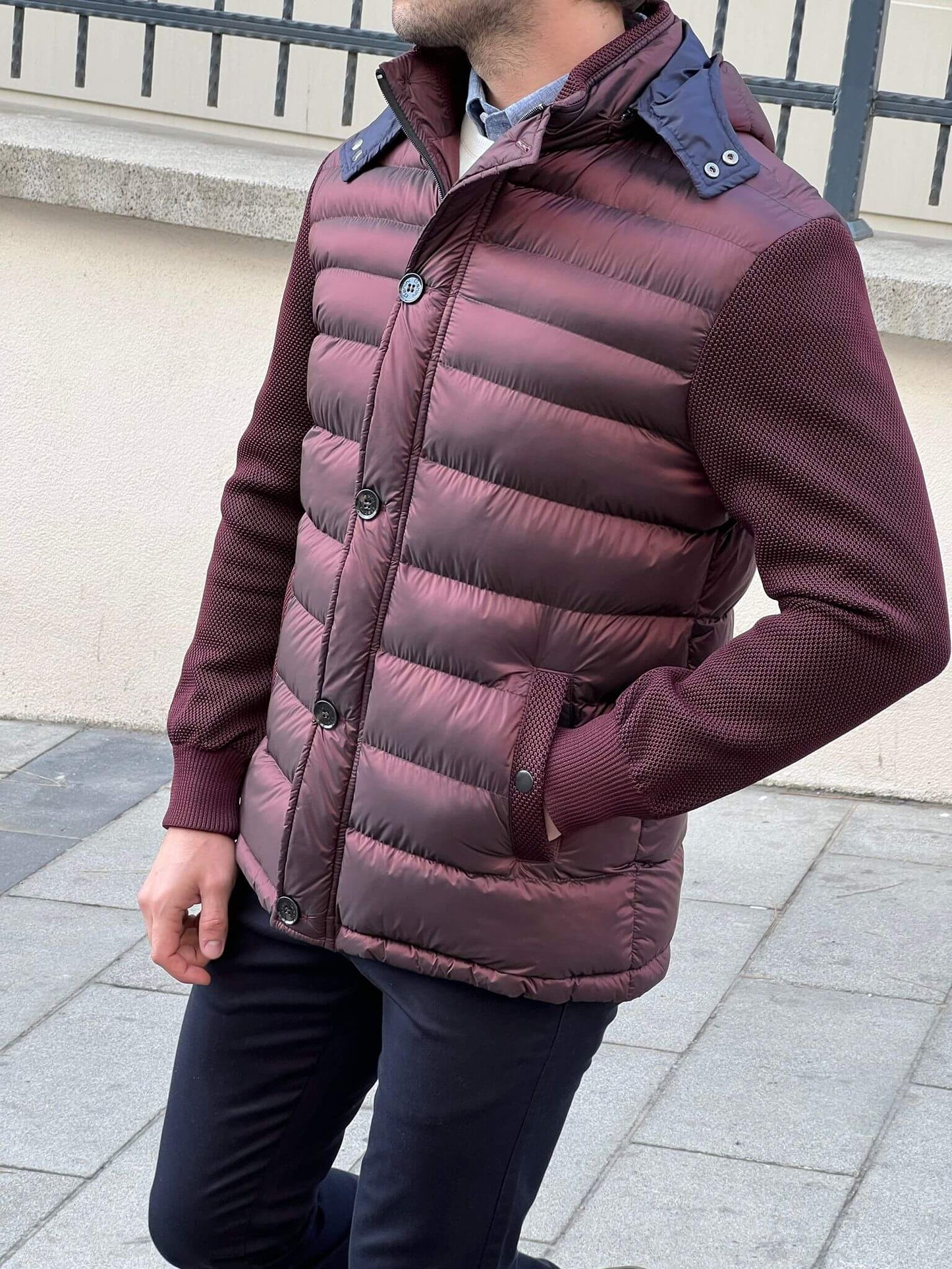 Chic and cozy: Our male model flaunts a knitted burgundy coat, a perfect blend of comfort and style.