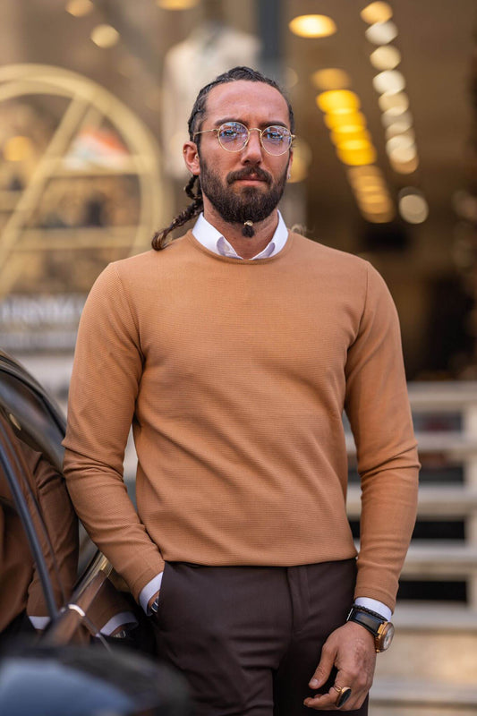 Experience the cozy allure of our camel crewneck on a stylish male model, embodying laid-back luxury.