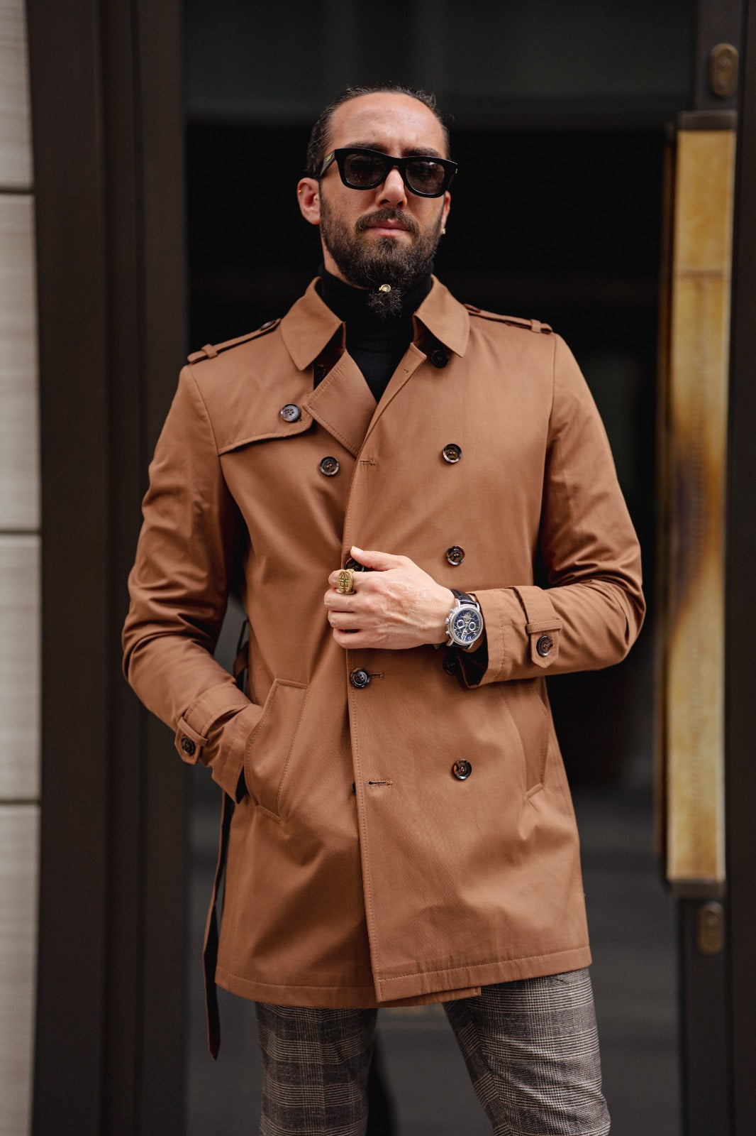 A Camel Trench Coat on display.