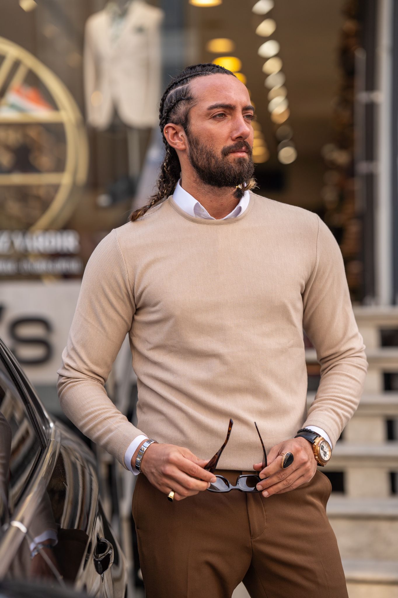 Embrace the warmth of our beige crewneck as modeled by our stylish and confident male fashion model.
