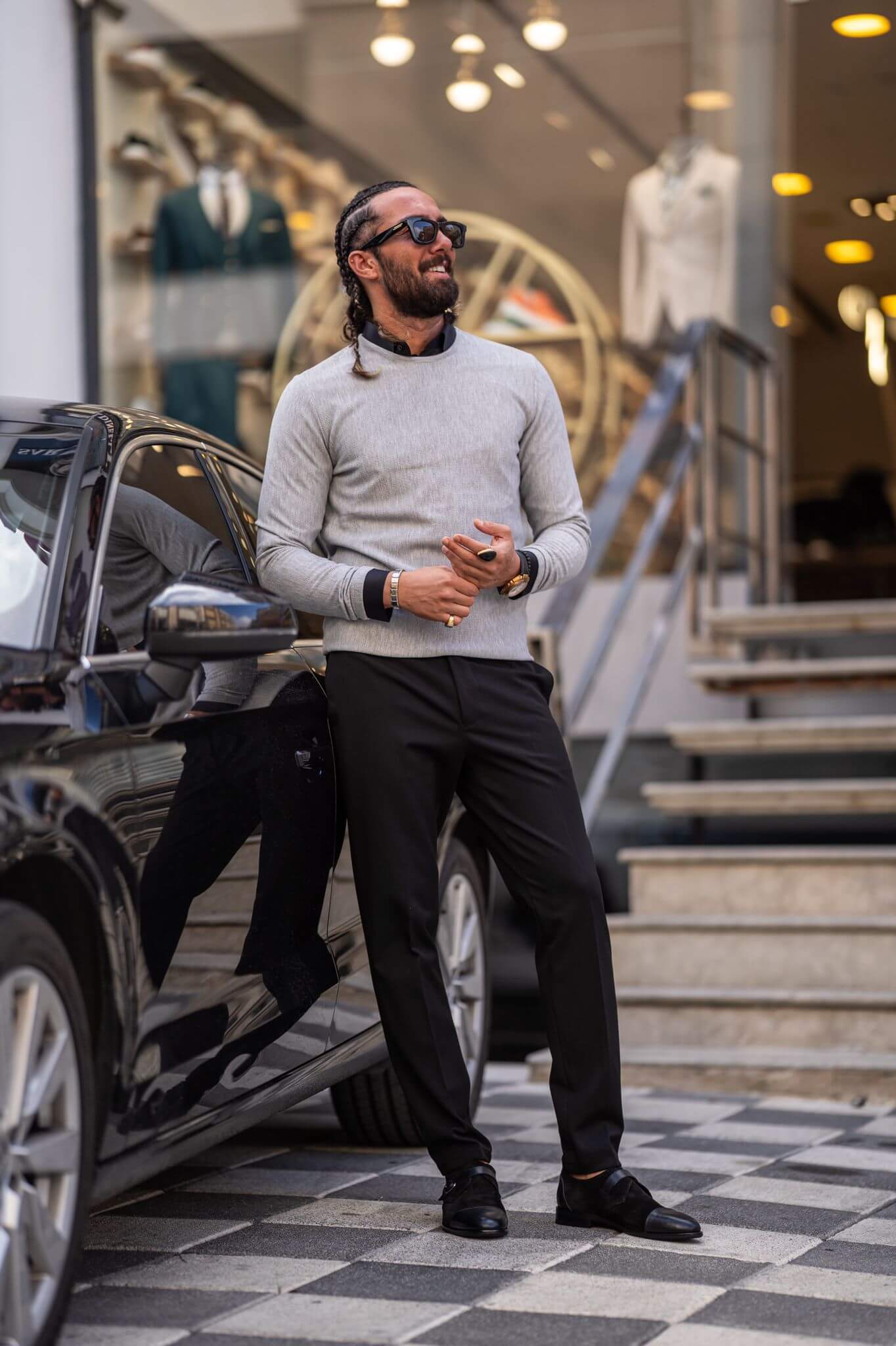 A stylish male model confidently displays our classic gray crewneck, showcasing its timeless appeal.