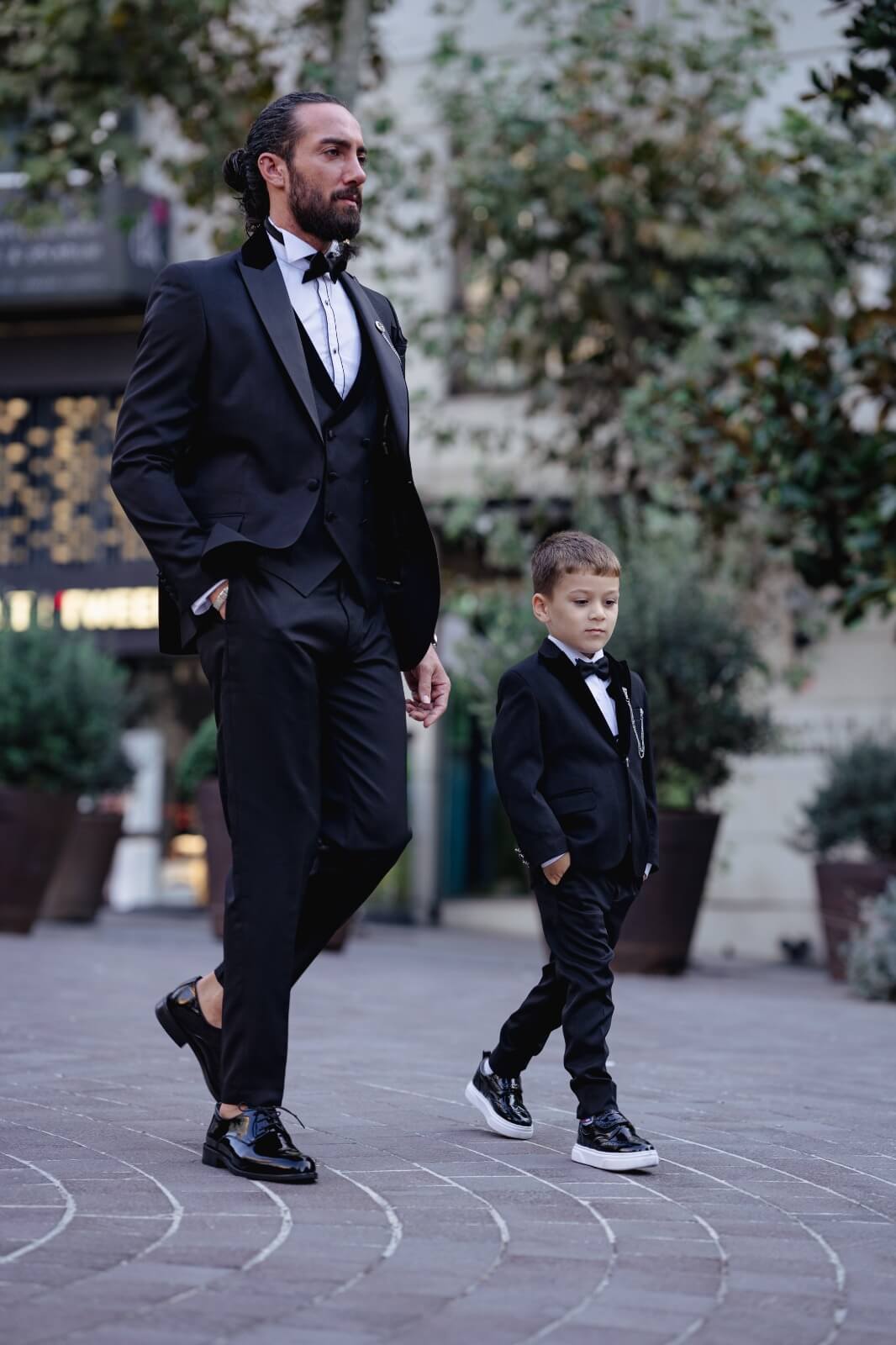 A slim-fit black boys’ tuxedo from HolloMen's Fall-Winter collection, designed with a single-button jacket, double slits, and full lining — perfect for weddings and formal occasions.