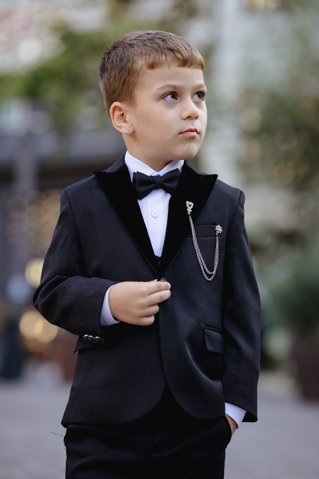 A slim-fit black boys’ tuxedo from HolloMen's Fall-Winter collection, designed with a single-button jacket, double slits, and full lining — perfect for weddings and formal occasions.