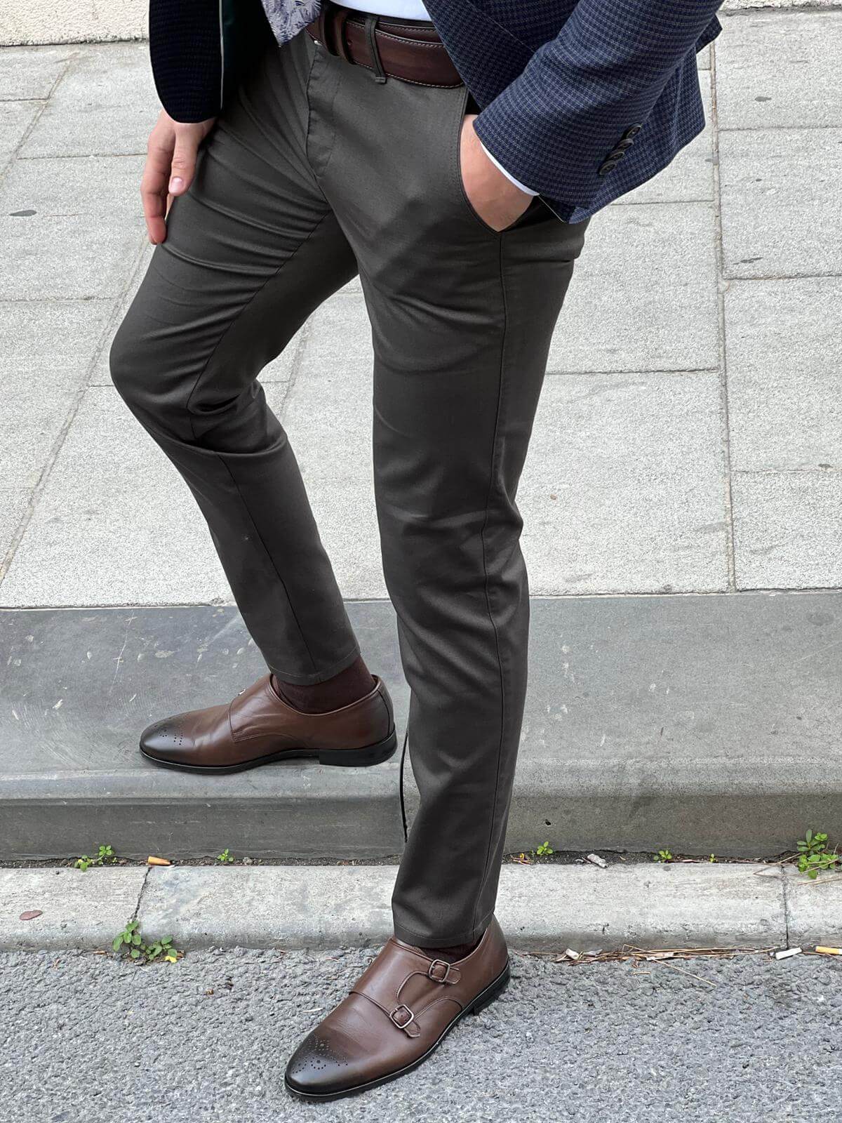 Stylish male model confidently presenting classic khaki pants with a modern twist, exuding sophistication and versatility in fashion.