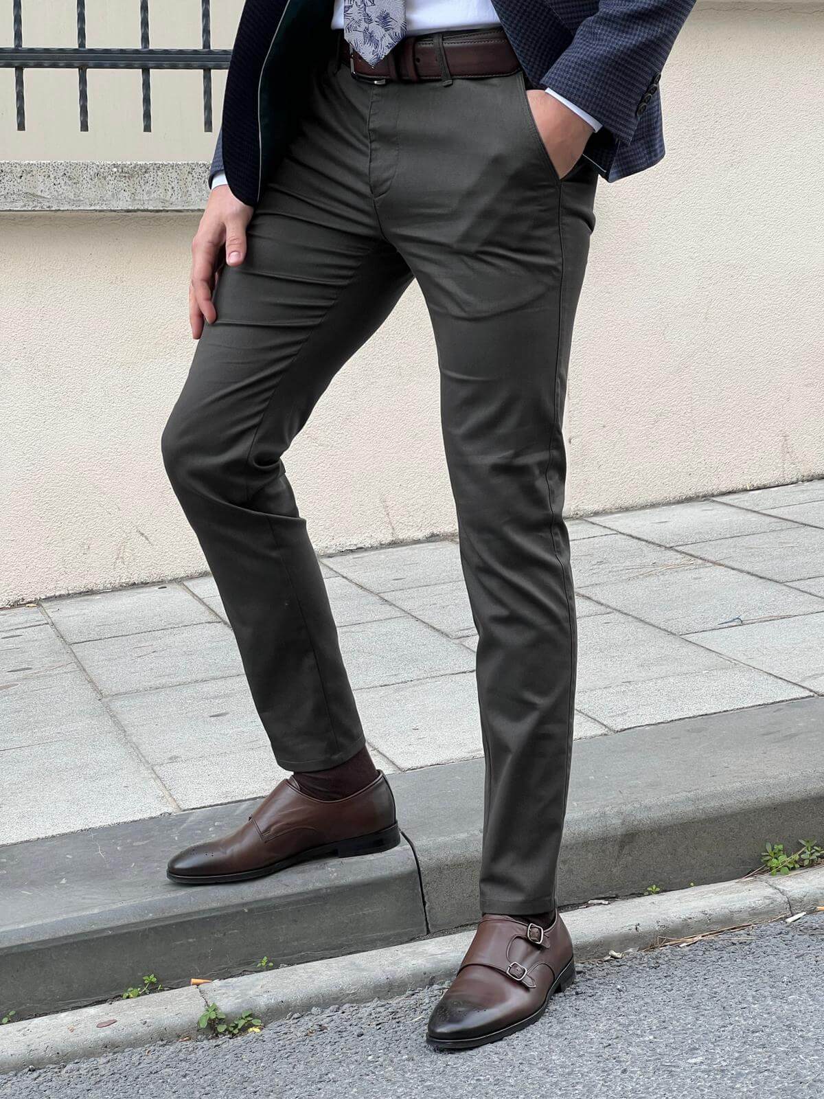 Stylish male model confidently presenting classic khaki pants with a modern twist, exuding sophistication and versatility in fashion.