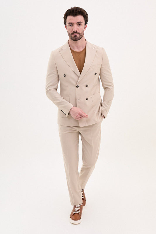 Man wearing a double-breasted beige suit with a casual brown shirt from HolloMen’s Spring Summer Collection.