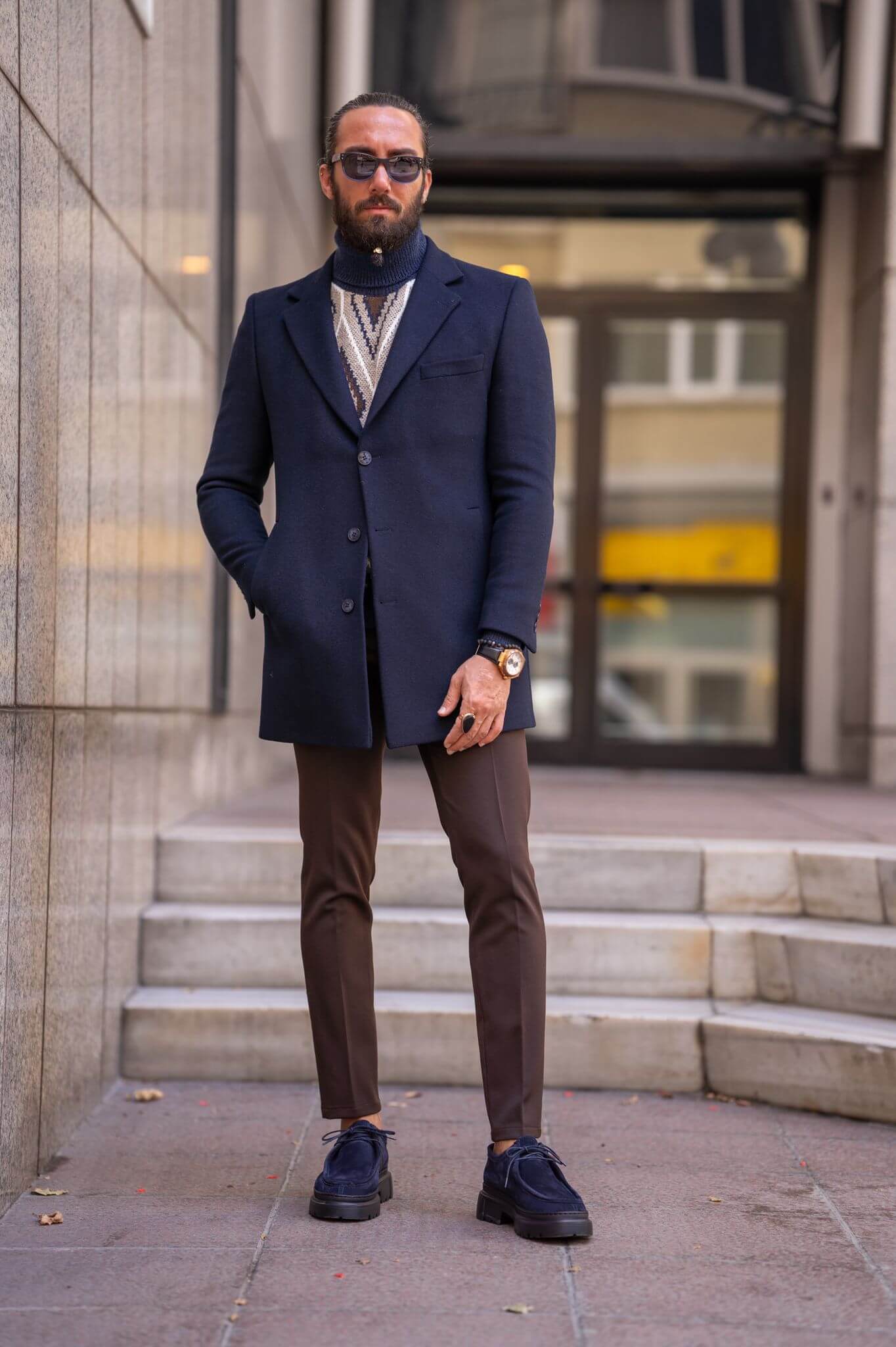 Striking male model confidently presents our latest fashion statement: the Navy Blue Coat,