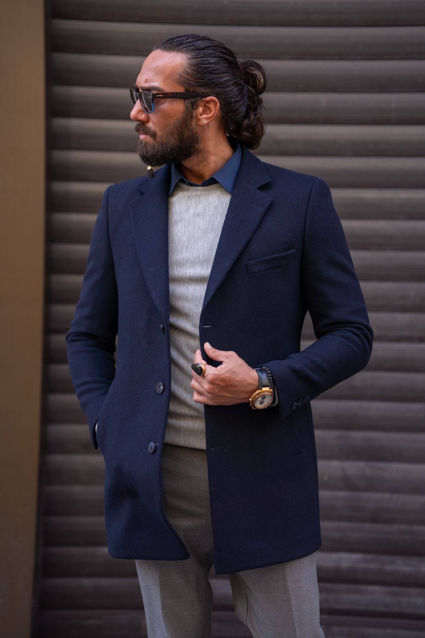 Confident male model exudes sophistication in our impeccably tailored navy blue coat.