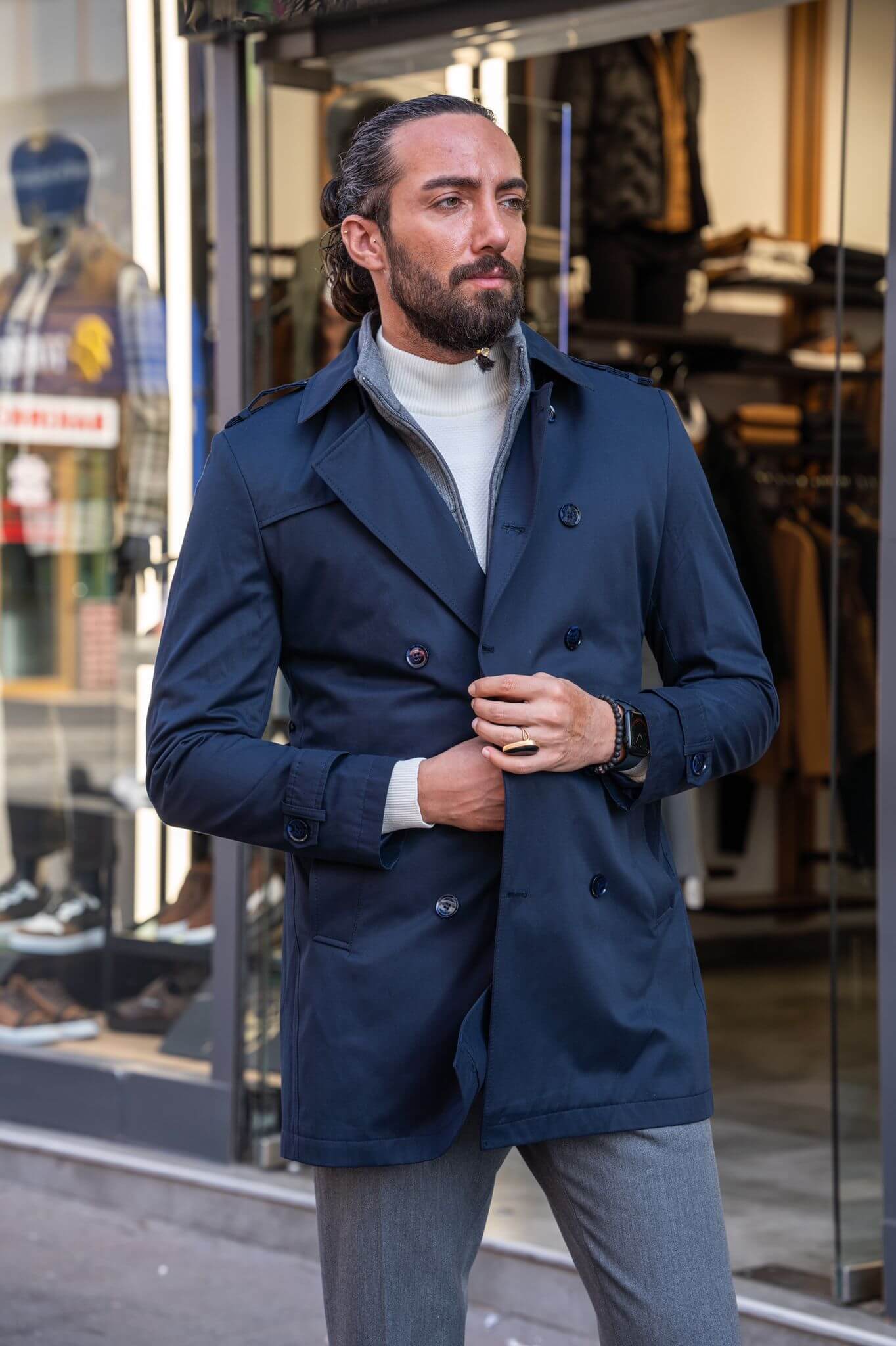 Chic and suave: our male model effortlessly rocks a navy blue trench coat