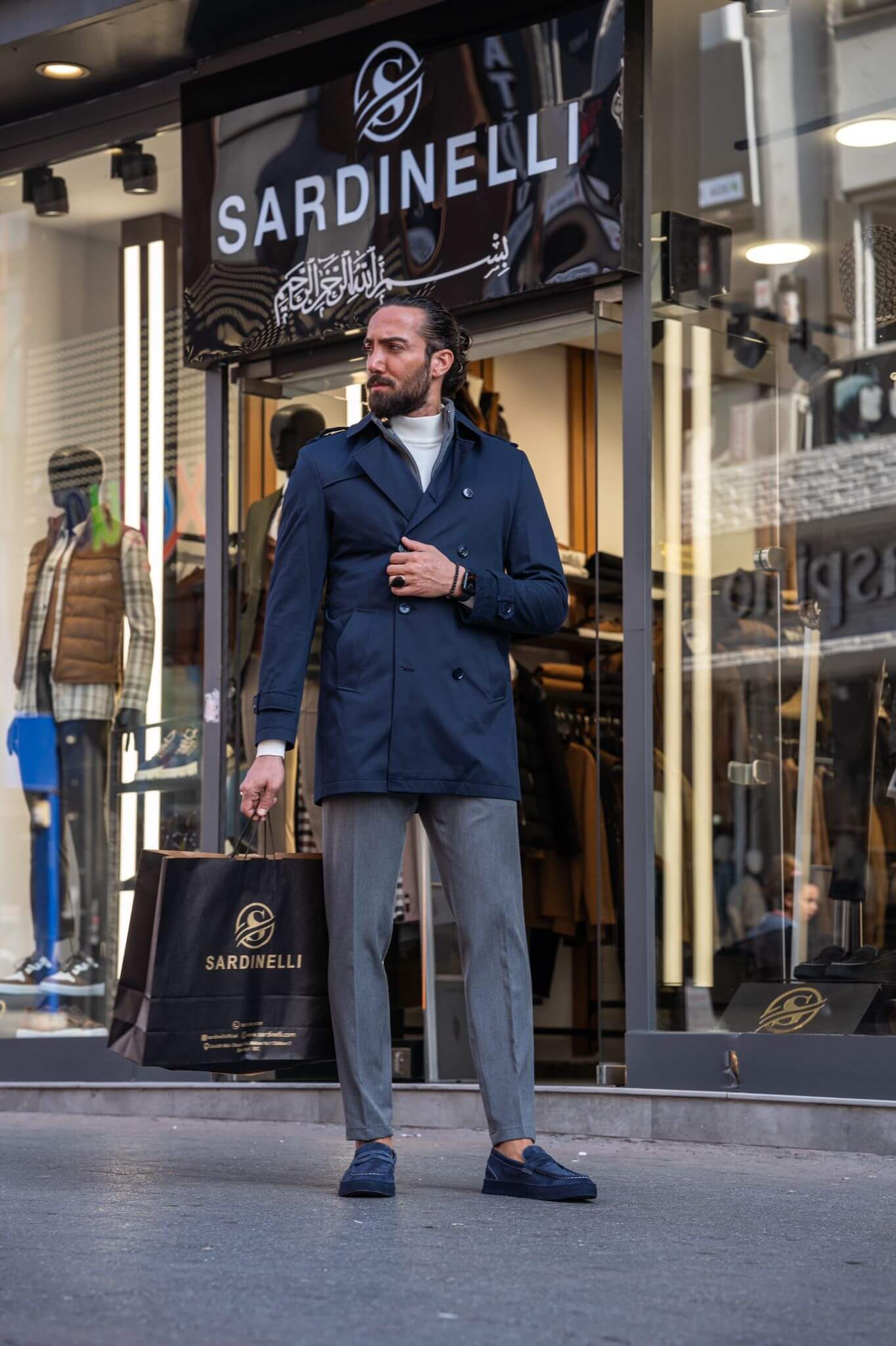 Chic and suave: our male model effortlessly rocks a navy blue trench coat