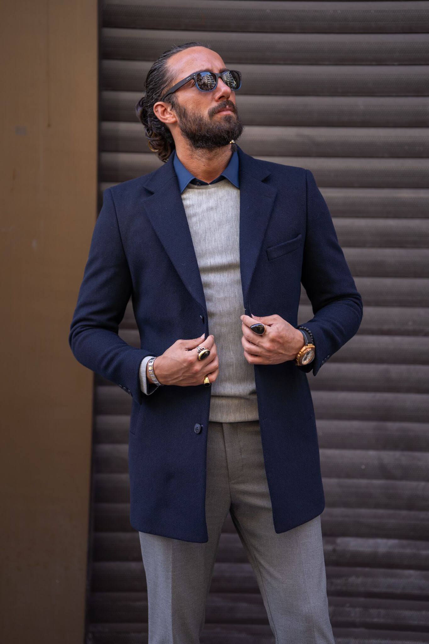 Confident male model exudes sophistication in our impeccably tailored navy blue coat