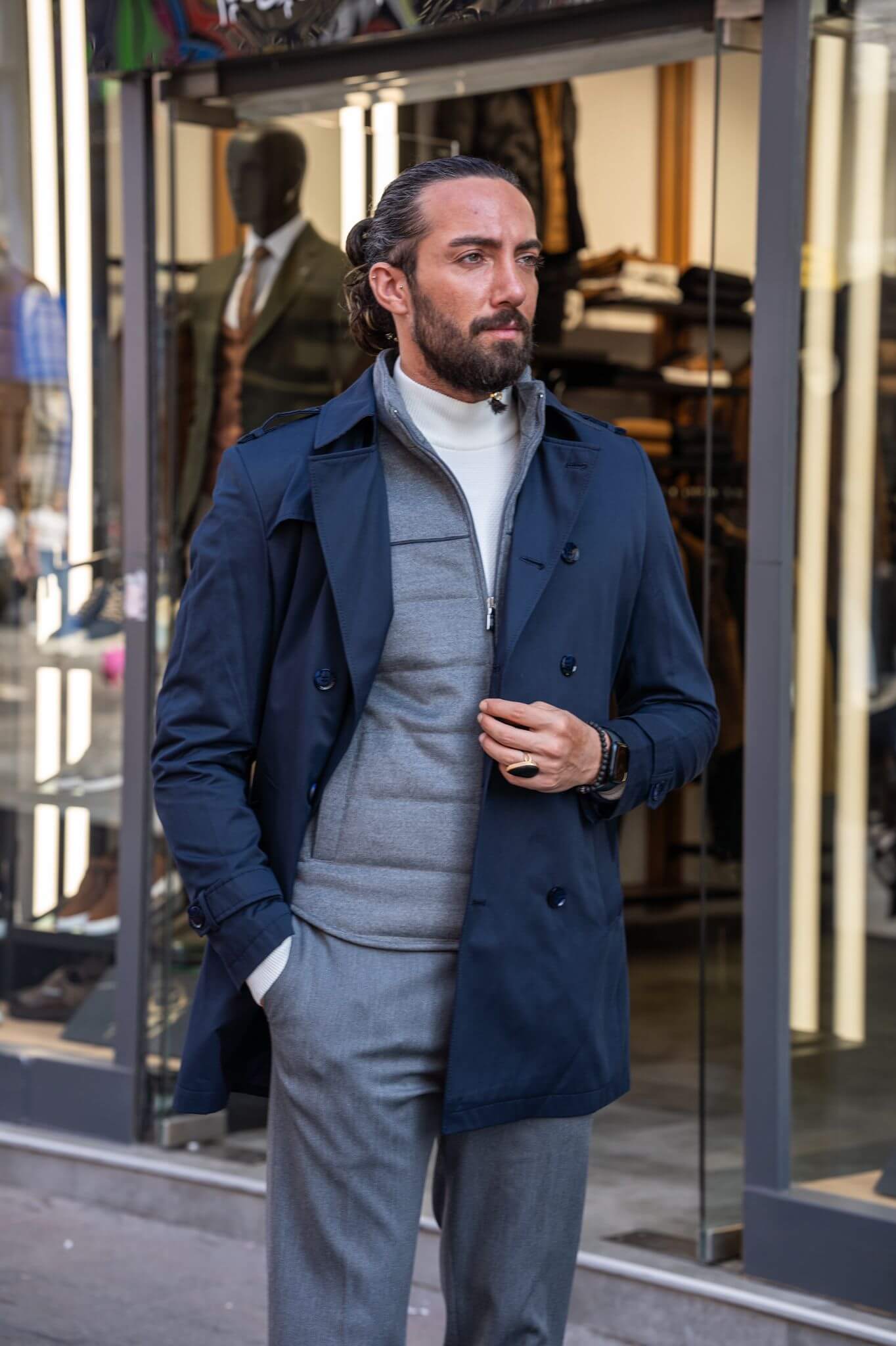 Chic and suave: our male model effortlessly rocks a navy blue trench coat.