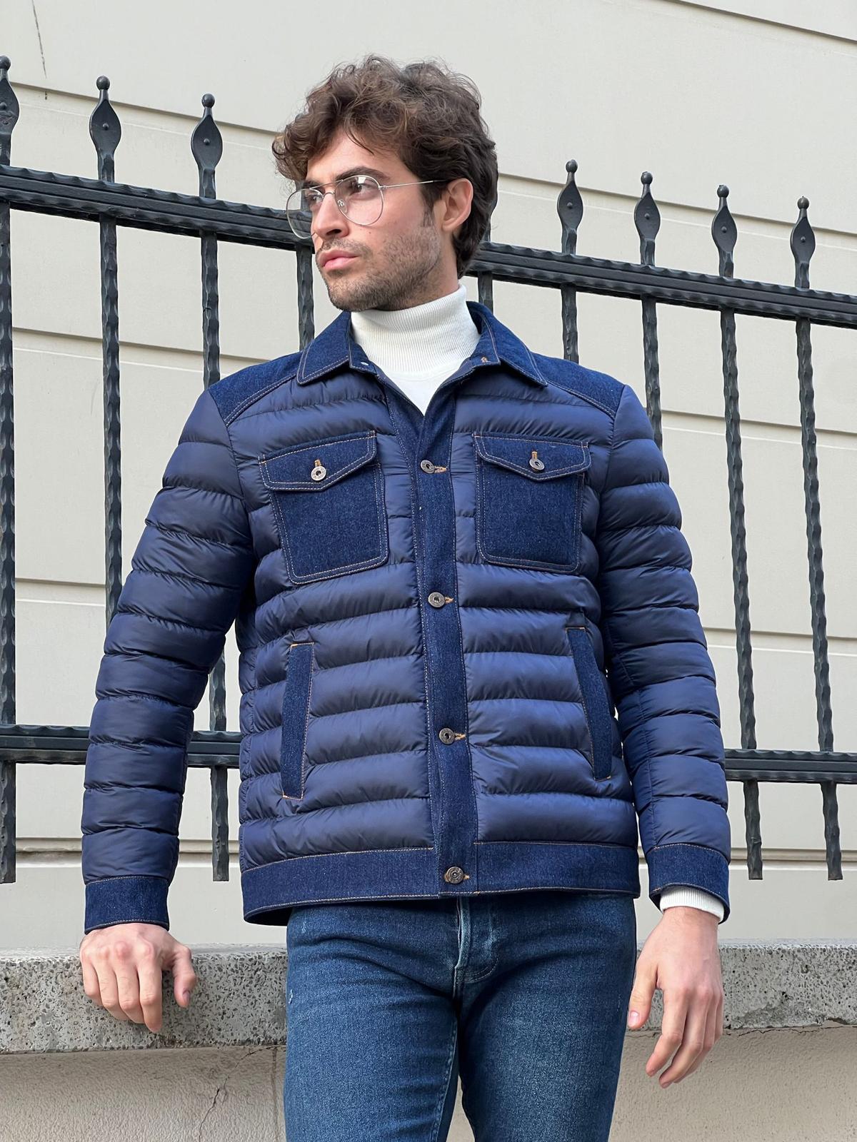 Confident male model in a stylish navy blue denim coat, exuding casual elegance.