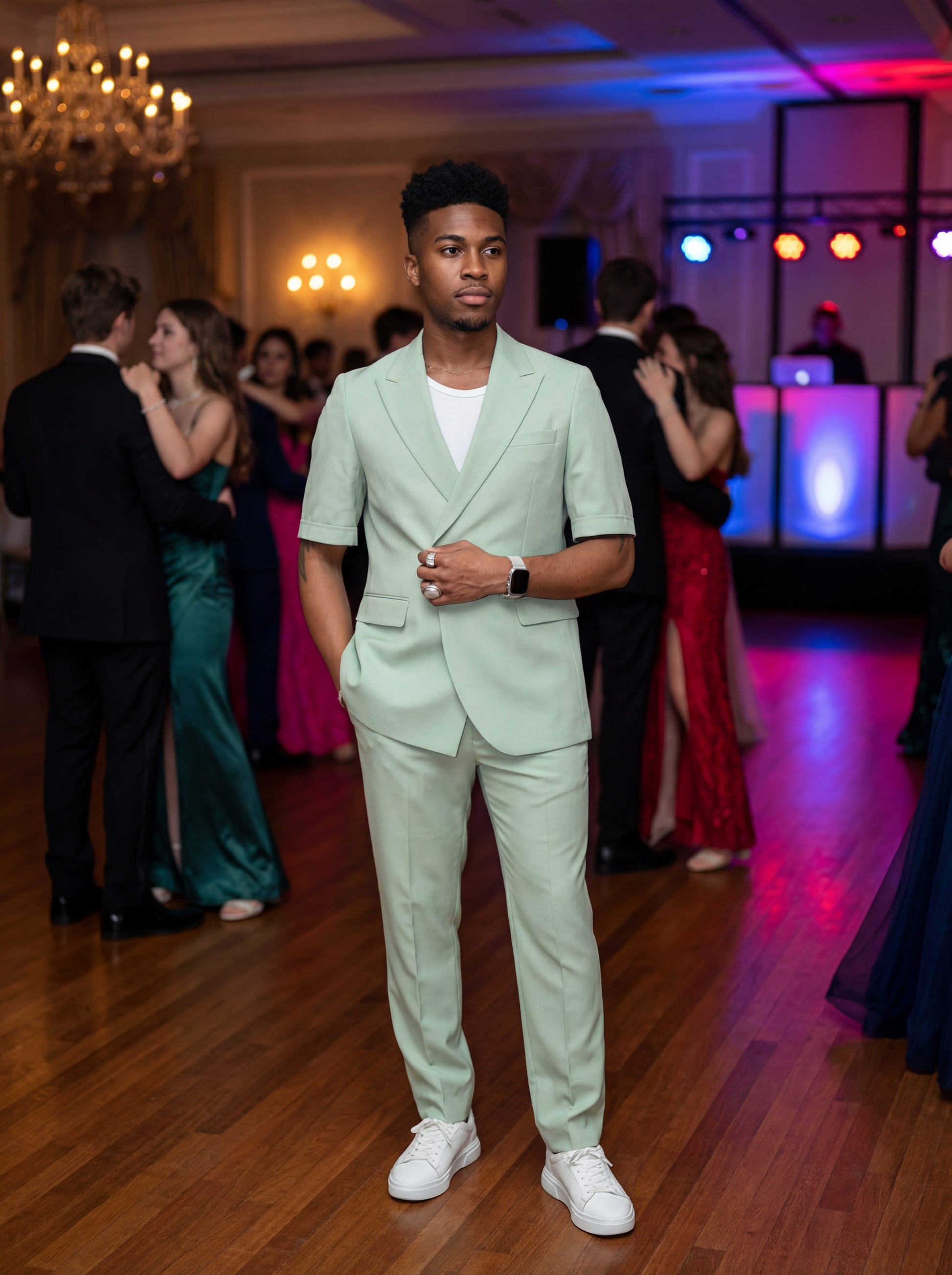 Mint green short sleeve prom suit worn by young male model