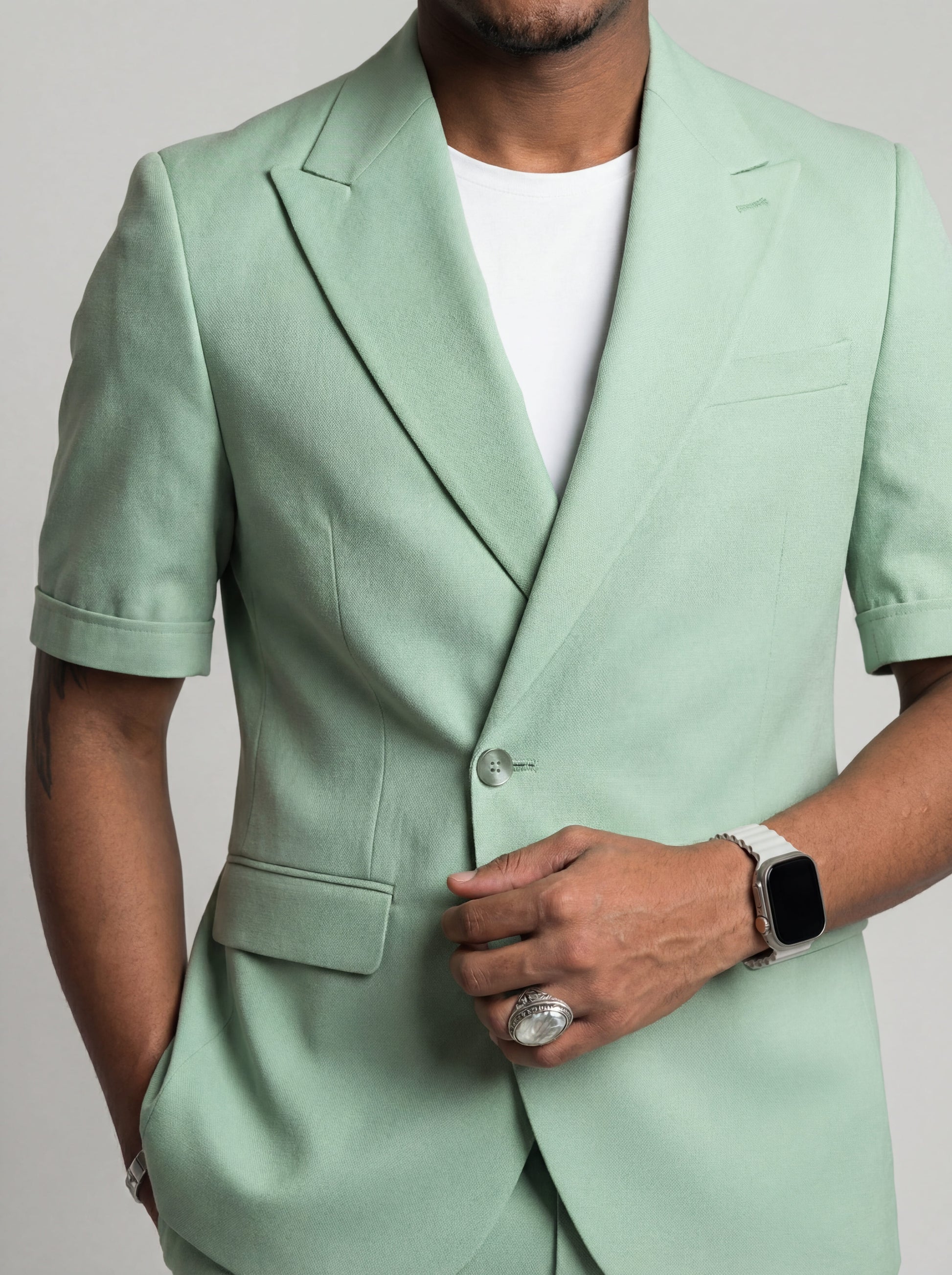 Mint green short sleeve prom suit worn by young male model