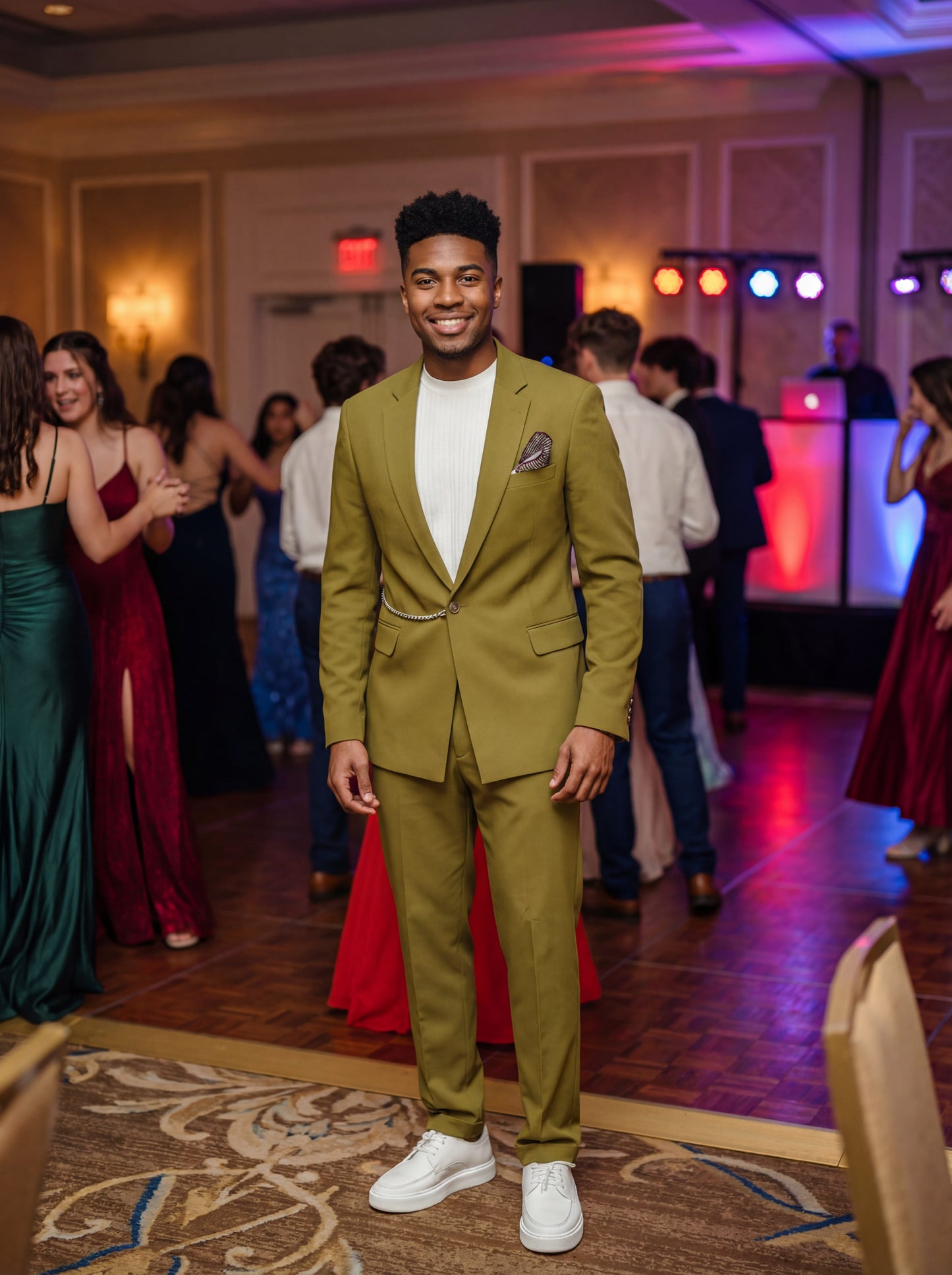 Olive green slim fit prom suit with chain detail worn by young male model