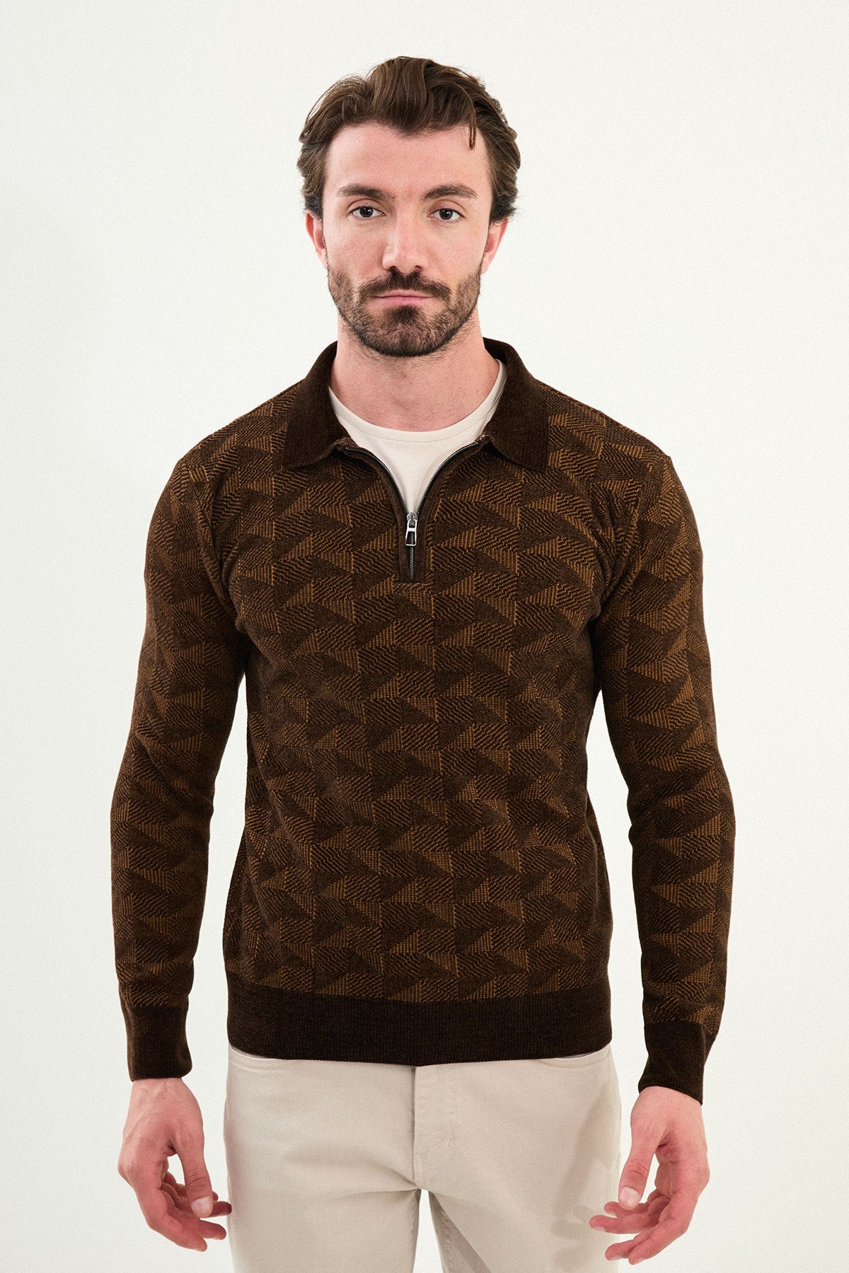 A male model wearing a brown patterned slim fit knitwear sweater with a half-zip and polo collar.