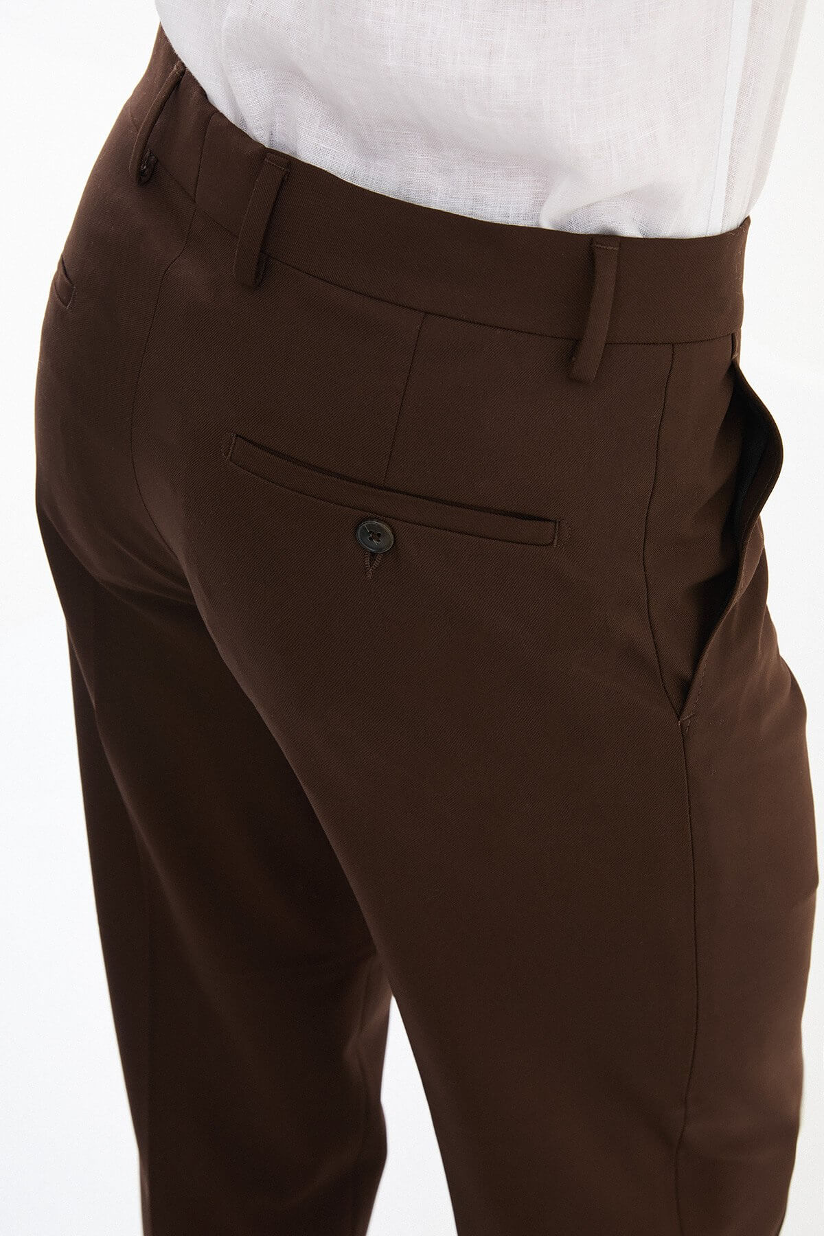 Men wearing brown slim-fit classic trousers, styled with formal shoes and a dress shirt, ideal for business and formal events.